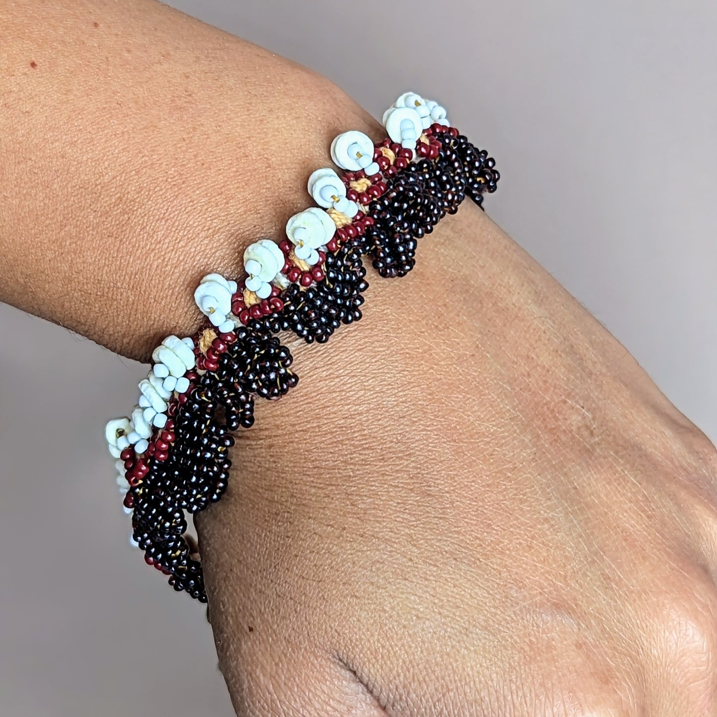 Earrings and bracelet from the Nia set displayed together, showcasing their harmonious earthy palette and sustainable handmade design.