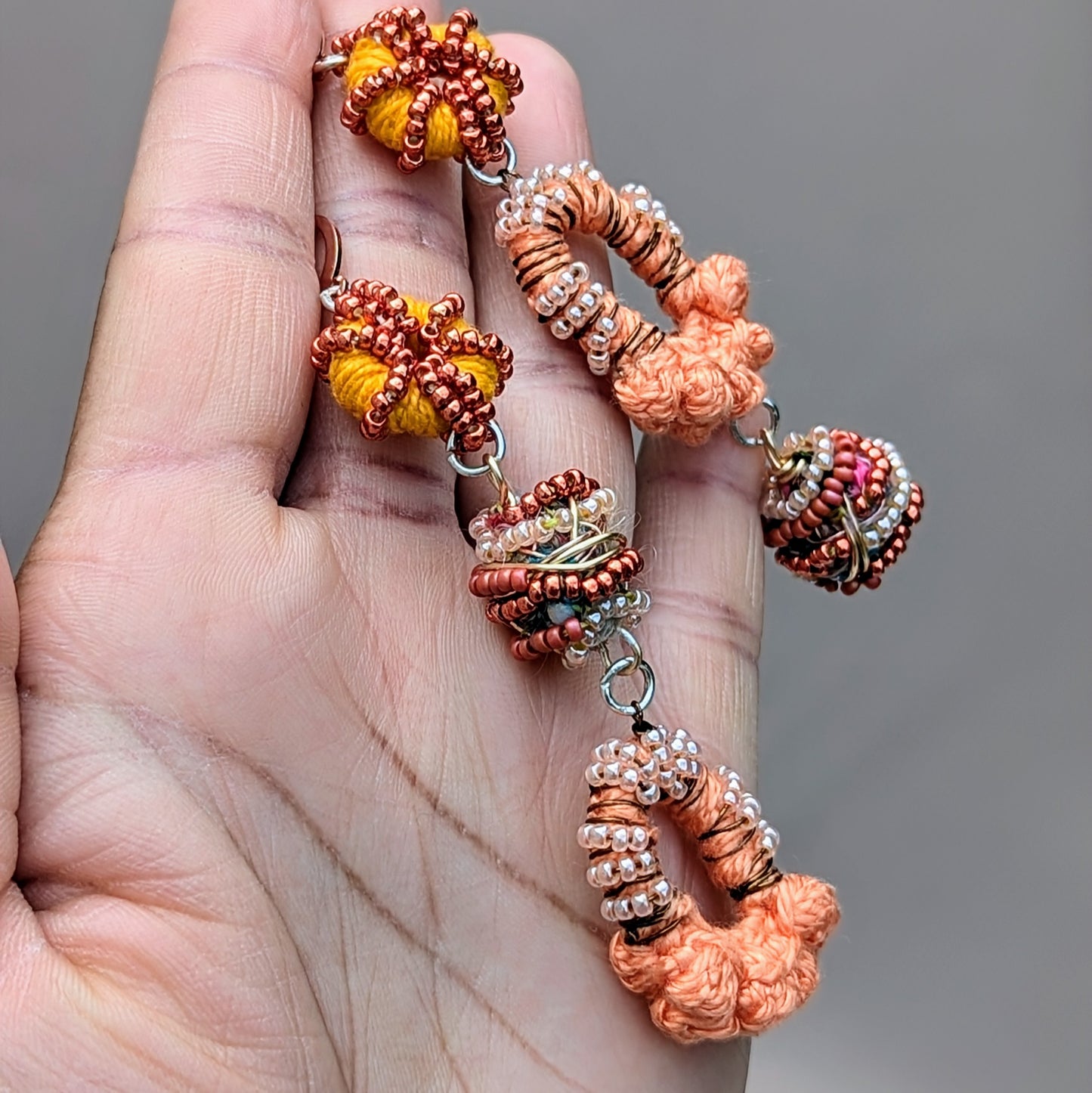 Experience the charm of these handcrafted Indian-style earrings in peach, orange, bronze, and rose gold, available exclusively from sustainable UK brand Mayaani Jewellery. Featuring signature concept beads made by in-house artisan Megha from scraps created during the jewellery-making process, these earrings celebrate artistry and sustainability. Perfect for weddings and special events, they also make a bold statement in sustainable fashion when worn every day.