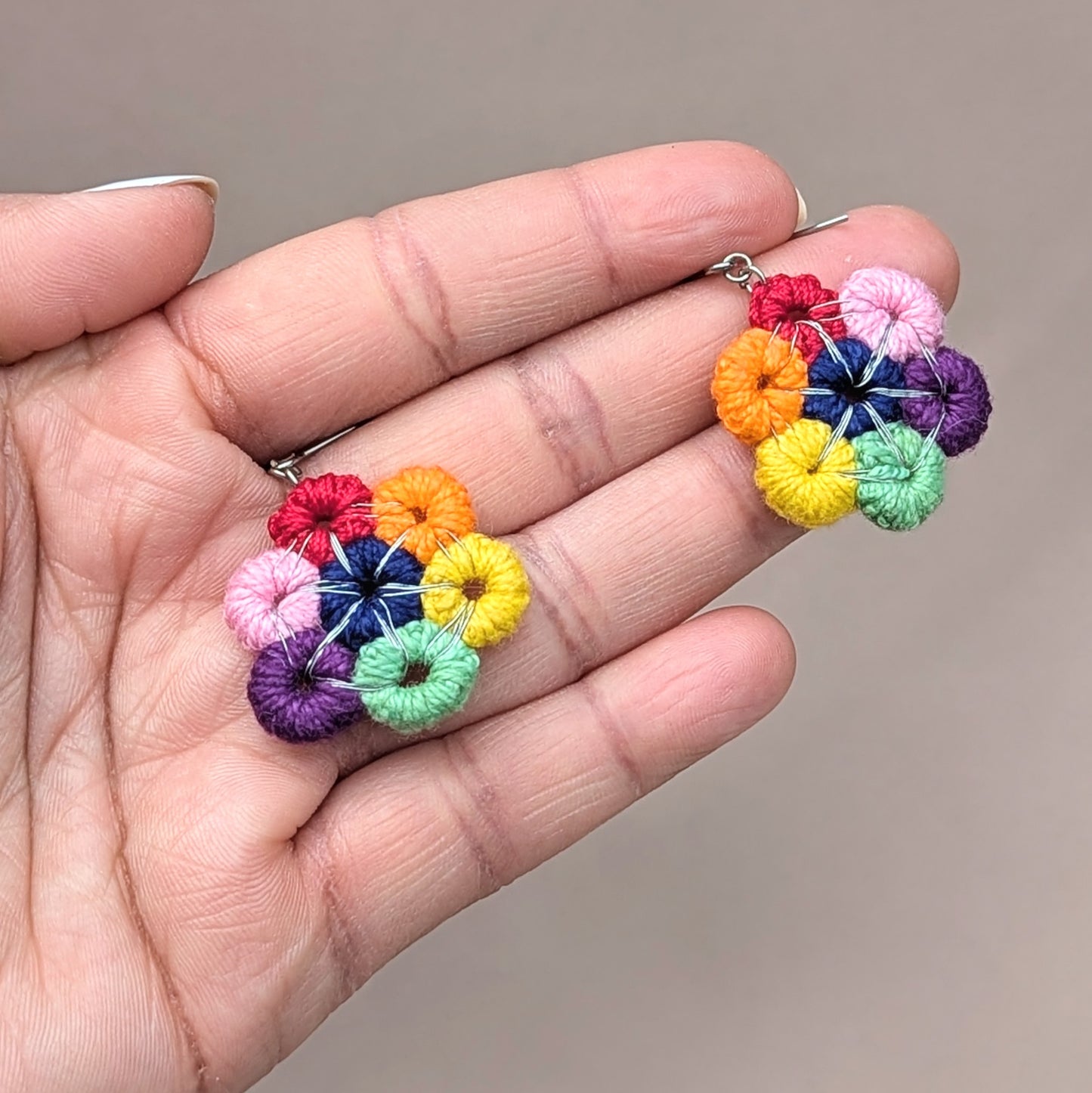 Celebrate the vibrant beauty of a circular rainbow with these handcrafted earrings, exclusively by the sustainable Indian brand Mayaani Jewellery UK. A perfect way to inject a burst of color that lifts your spirits and enhances your daily attire! Designed with hand-crocheted circles wrapped in silver-plated copper wire, these bold earrings are completed with reliable stainless steel hooks.