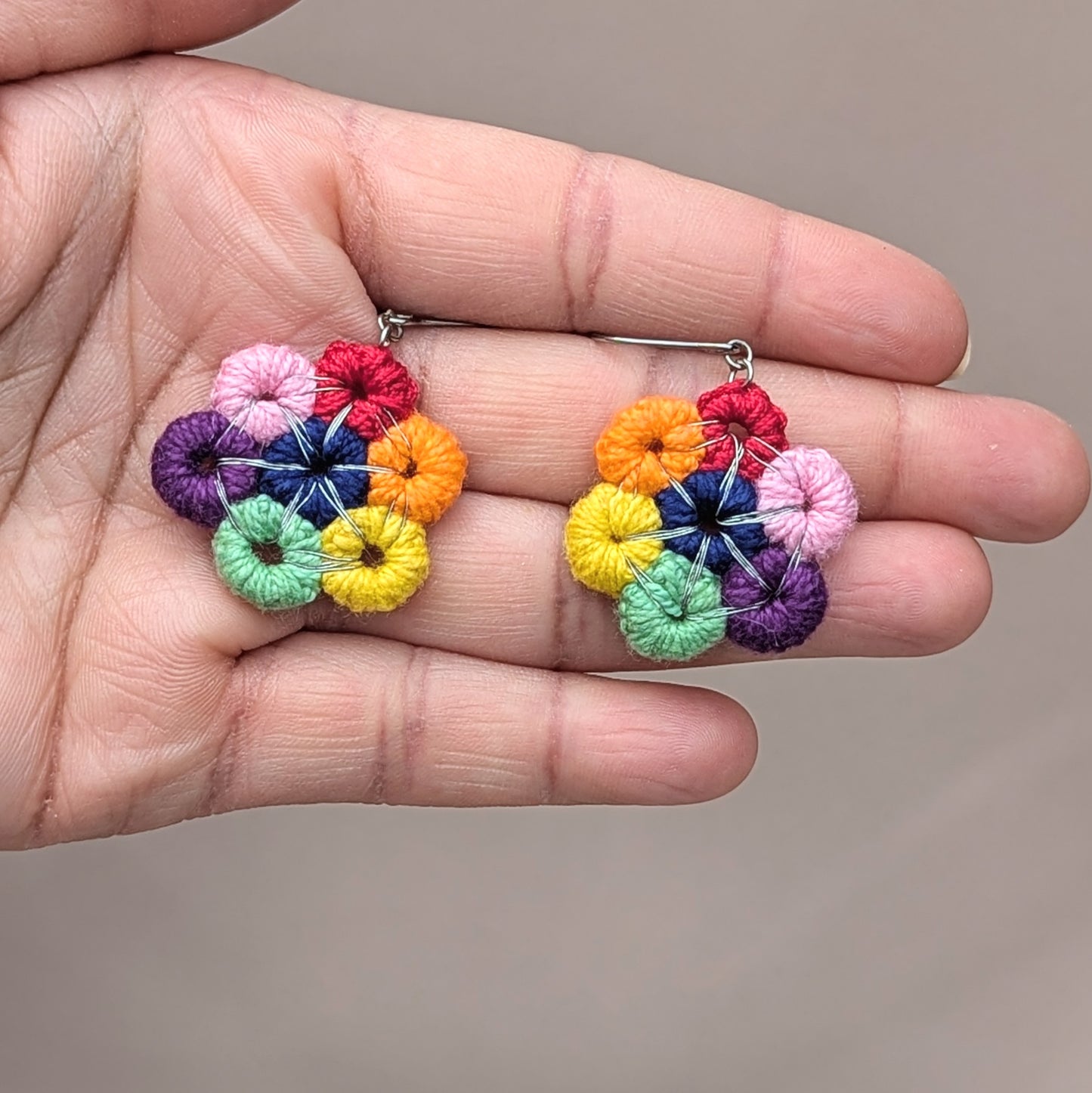 Indulge in the vibrant hues of a circular rainbow with this exquisite pair of handcrafted earrings, exclusively from Mayaani Jewellery UK, a sustainable Indian brand. They add a lively touch of color to uplift your mood and transform your look in an instant! Featuring hand-crocheted circles elegantly wrapped in silver-plated copper wire, these earrings come with durable stainless steel hooks for a bold finish.