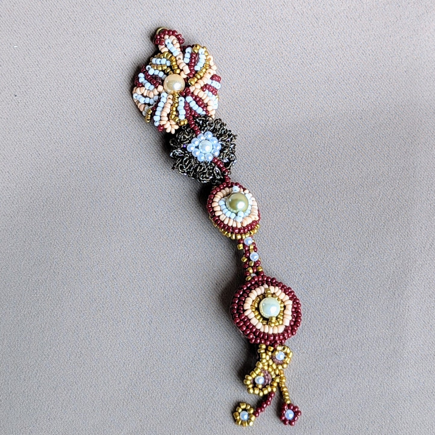 A close-up of an Indian bridal tikka exclusively handcrafted for Mayaani Jewellery UK using a combination of bead embroidery, crochet and wire work. This artisanal piece can easily be styled beyond your wedding day. Modern traditional heritage inspired jewellery designed to flow with your life.