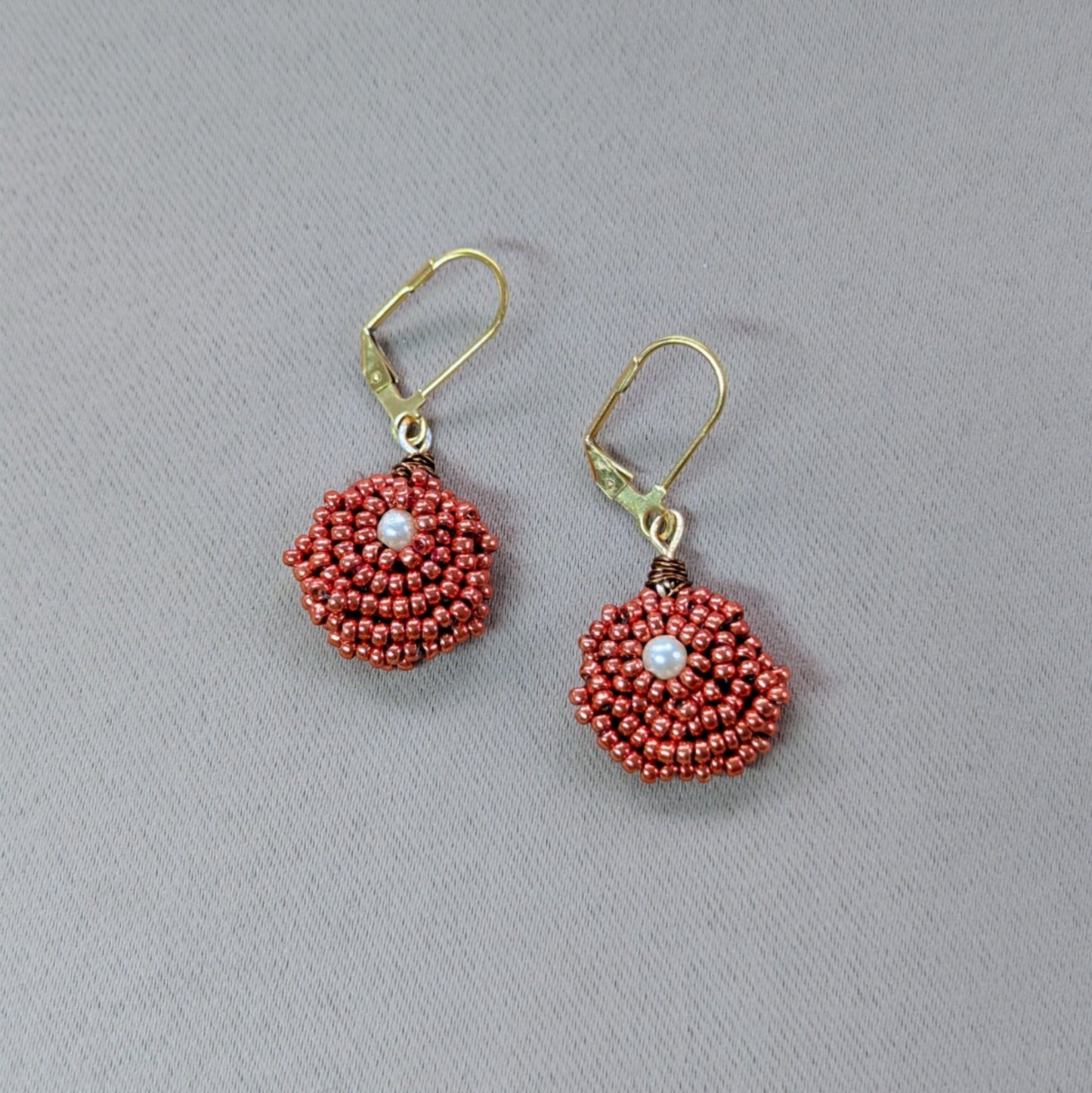 One-of-a-kind handmade Indian inspired copper Miyuki seed bead earrings with vintage pearl centres of gold hypoallergenic clasps.