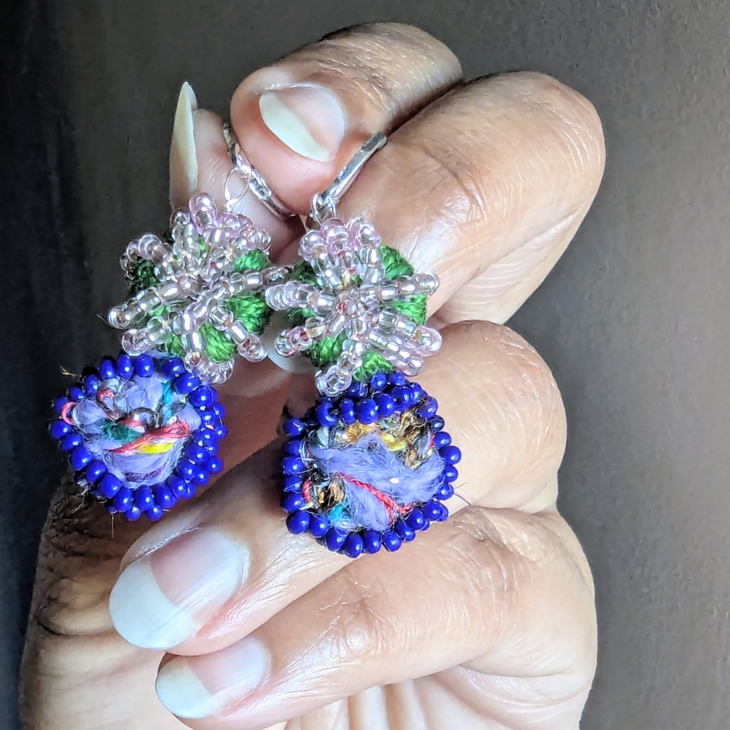 Macro shot of Gaia bead centre showing recycled materials and precise wire wrapping.