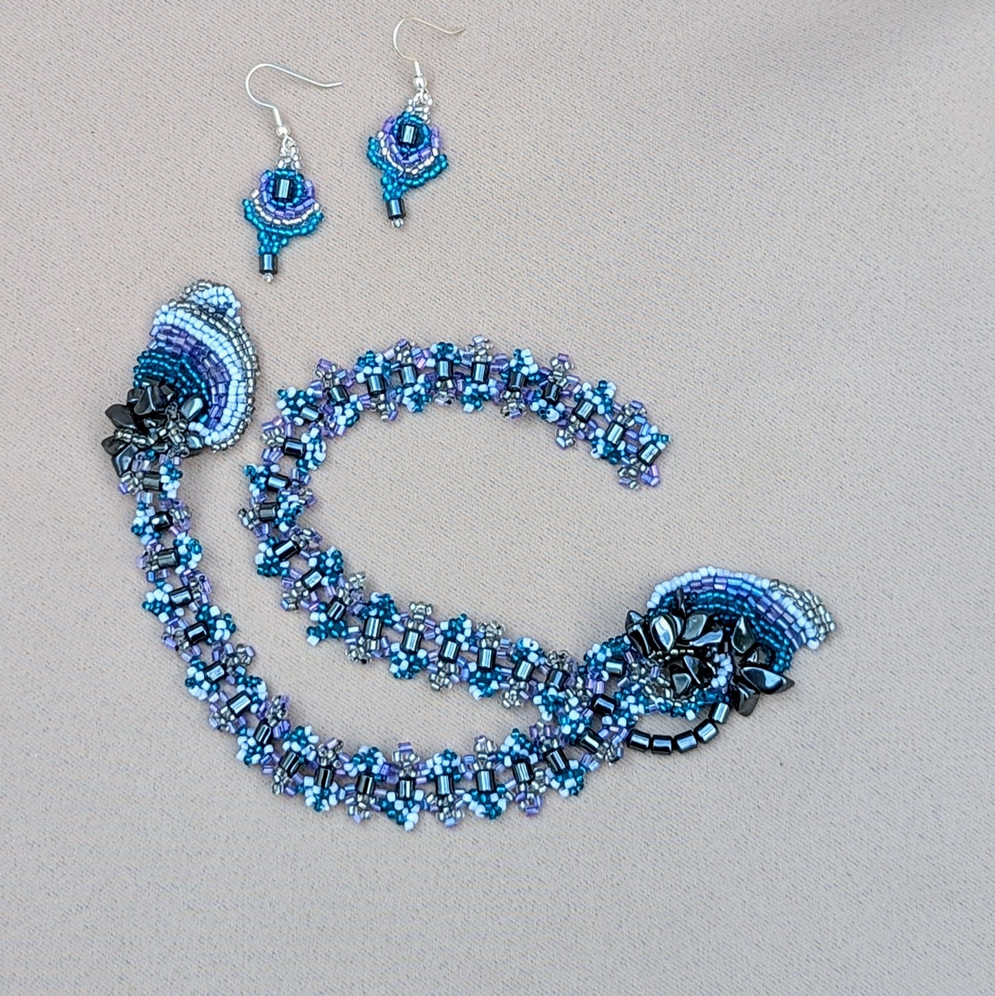 Matching lilac and hematite earrings paired with upcycled beaded necklace handmade by Mayaani Jewellery.