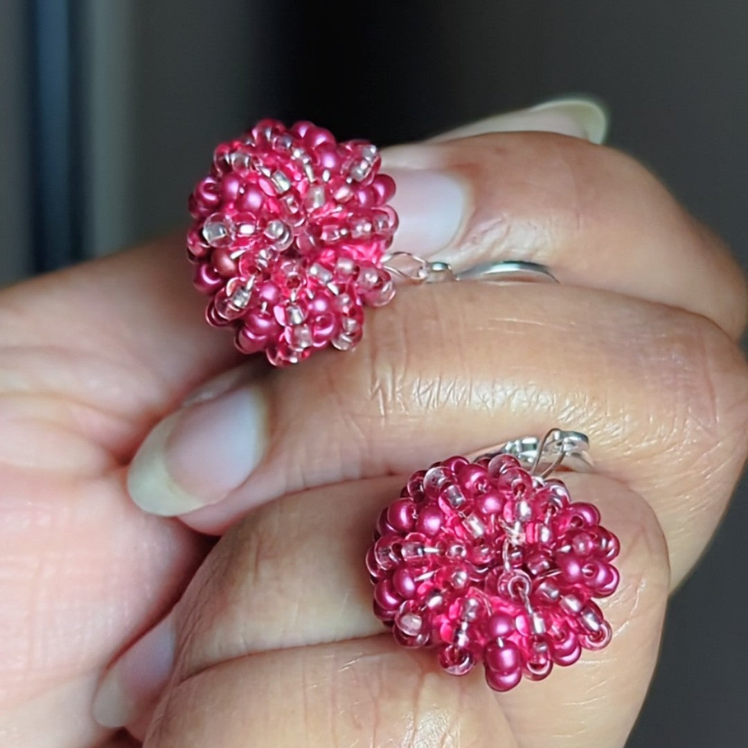 Close view of circular crochet-style earrings in metallic pink tones, designed by Mayaani Jewellery