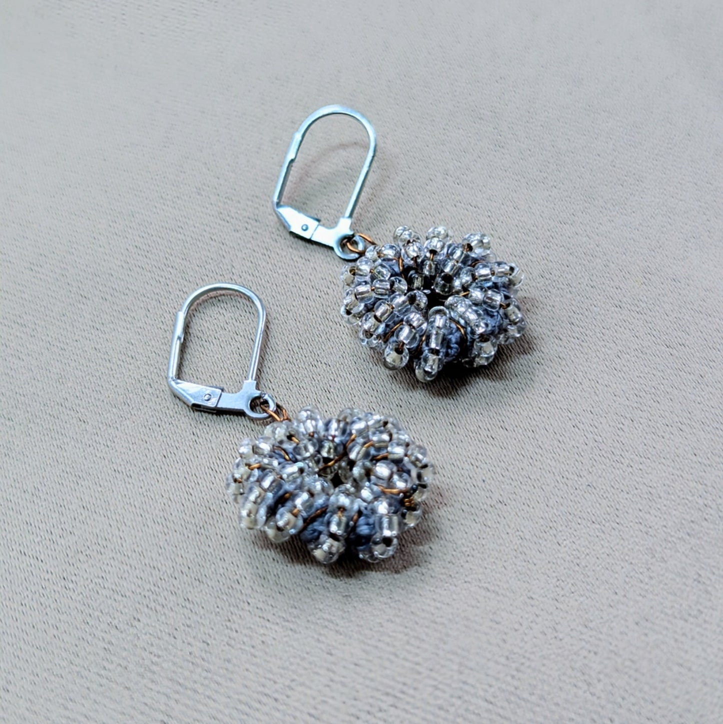 One-of-a-kind silver-grey glass bead earrings radiating soft shimmer.