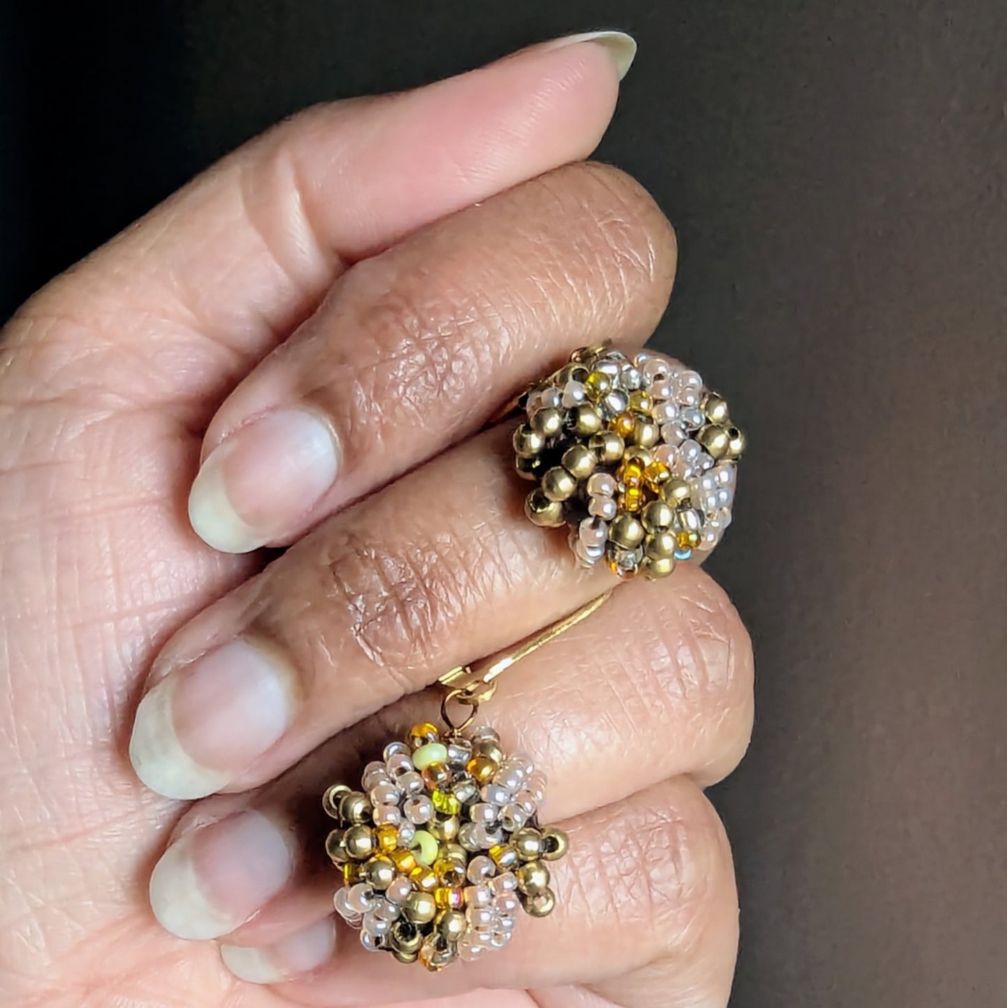 Artisan-crafted golden earrings designed by Indian designer Megha.