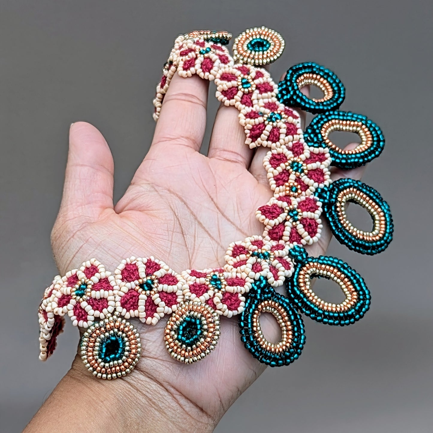 Traditional yet modern Indian bridal necklace in rich red and emerald green with peach and gold, designed for versatile wear in line with the core values of Mayaani Jewellery UK.