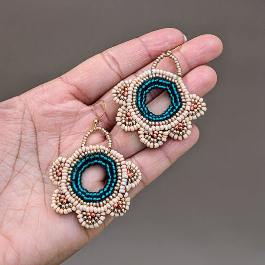 Handmade Neha bridal earrings in emerald green, peach and gold with circular beadwork and crochet detailing exclusive to sustainable brand Mayaani Jewellery UK.