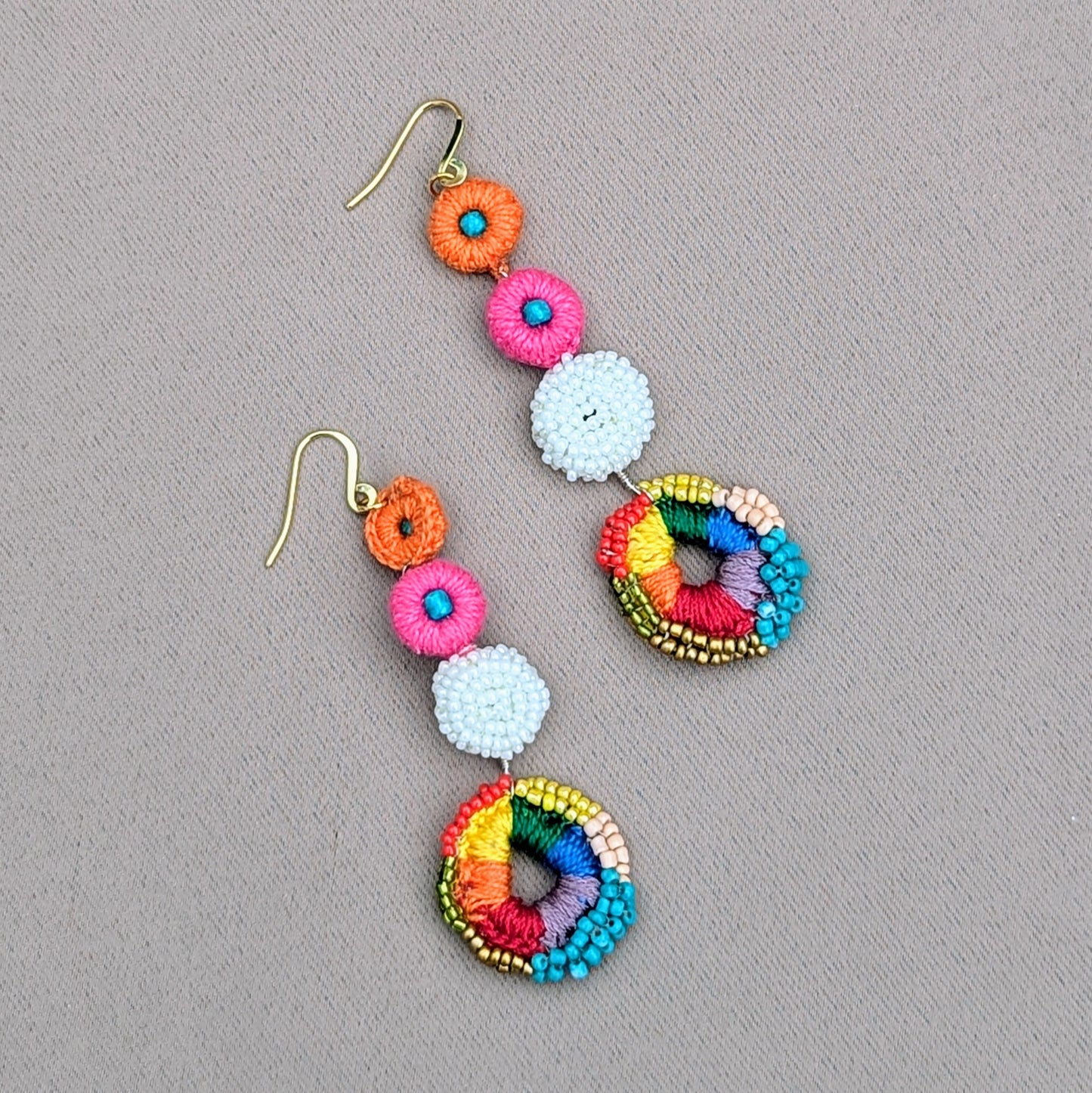 Indian-inspired statement earrings in rainbow tones with intricate crochet and sustainable bead detailing, part of the Ishya one-of-a-kind collection by Mayaani Jewellery.