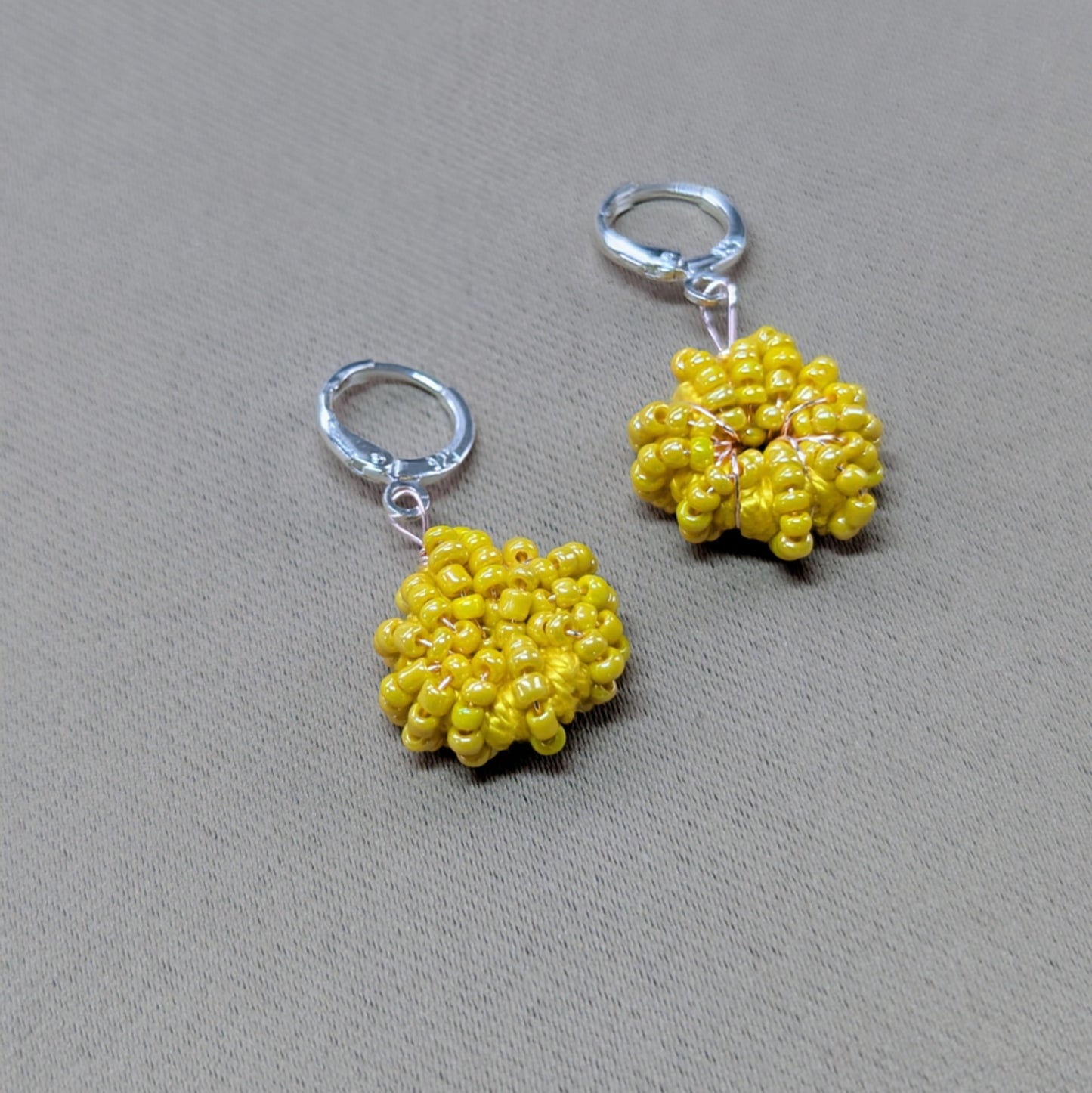 Raiya handmade yellow beaded hoop earrings featuring vintage upcycled glass seed beads, rose-gold plated wire and 925 sterling silver clasps.