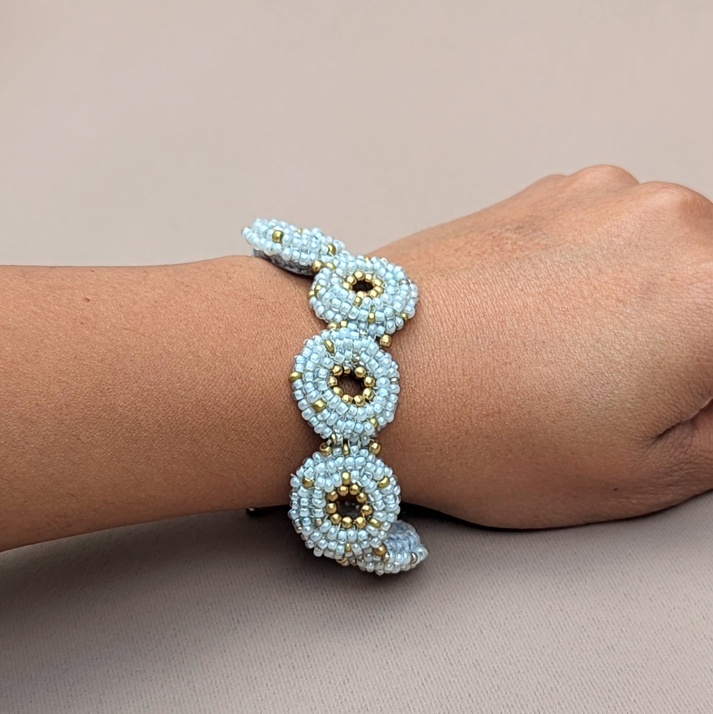 Artisanal winter-themed bracelet in silver-blue and gold tones, one of a kind by Mayaani Jewellery.
