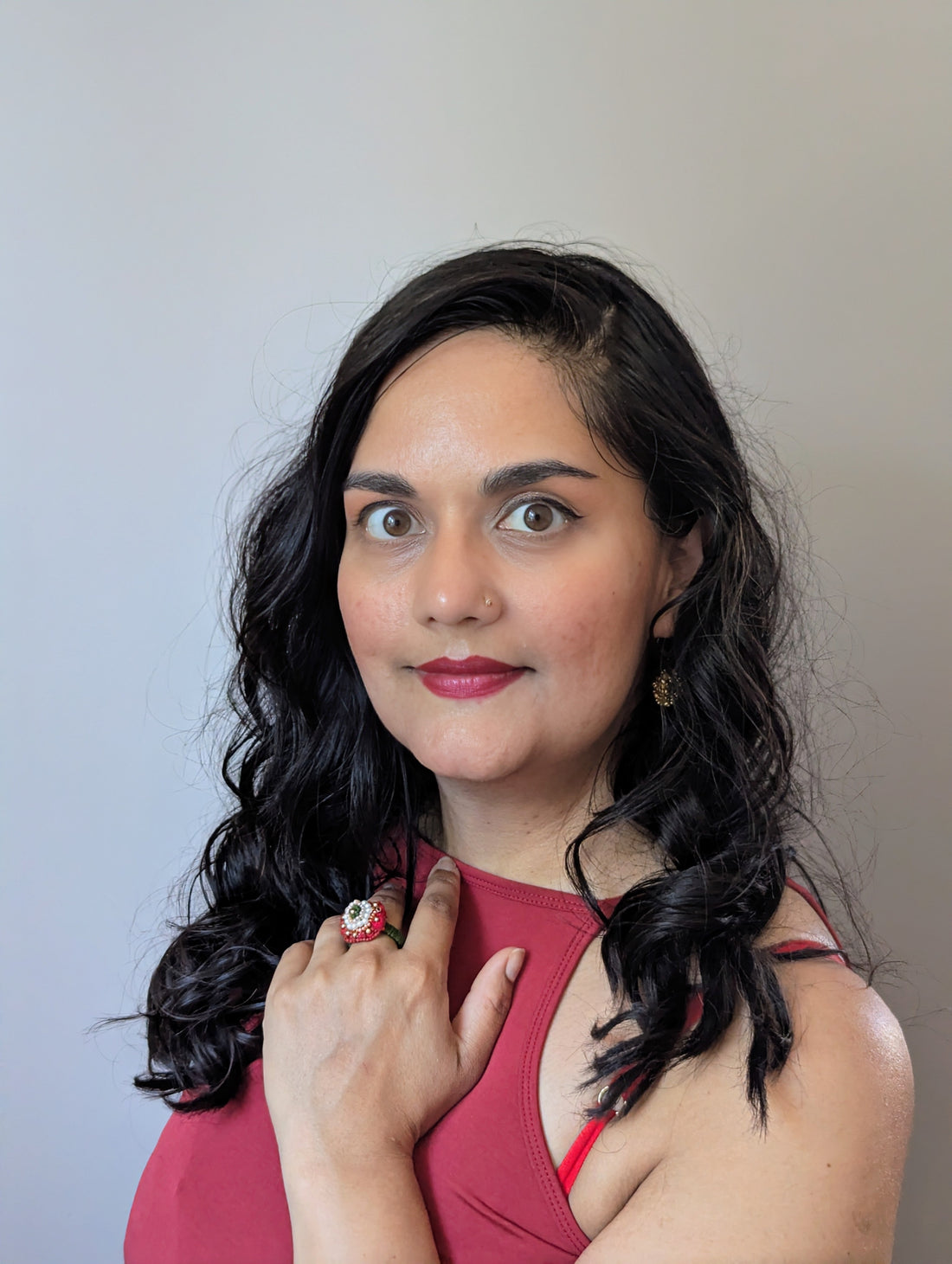 Megha wearing handcrafted red and green Indian jewellery she designed and made