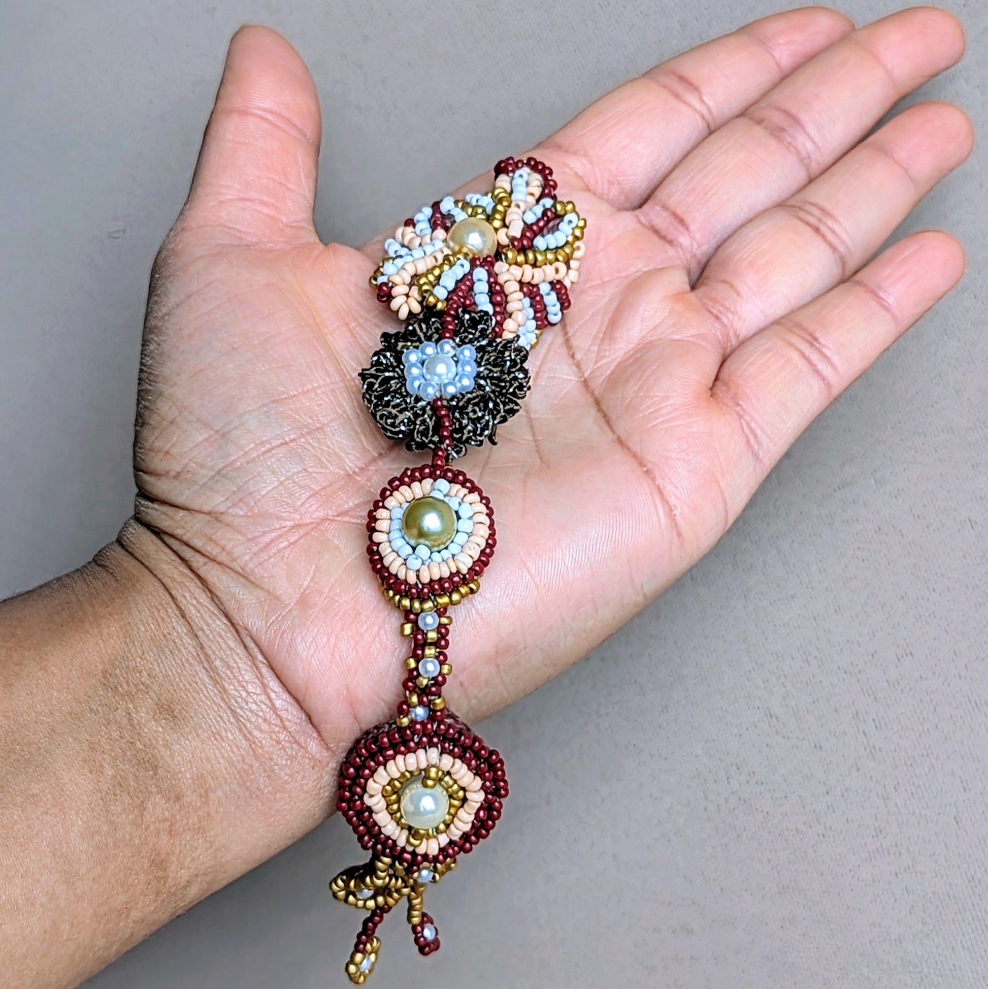 Explore the artistry of Mayaani Jewellery's handcrafted Indian bridal headpiece, a proud offering from a sustainable UK brand. This exceptional piece highlights intricate hand-crochet, beautiful hand-beading, and meticulous hand wire-wrapping. Its versatile design allows you to wear it as a headband or tikka, providing a variety of styling options for future wear.