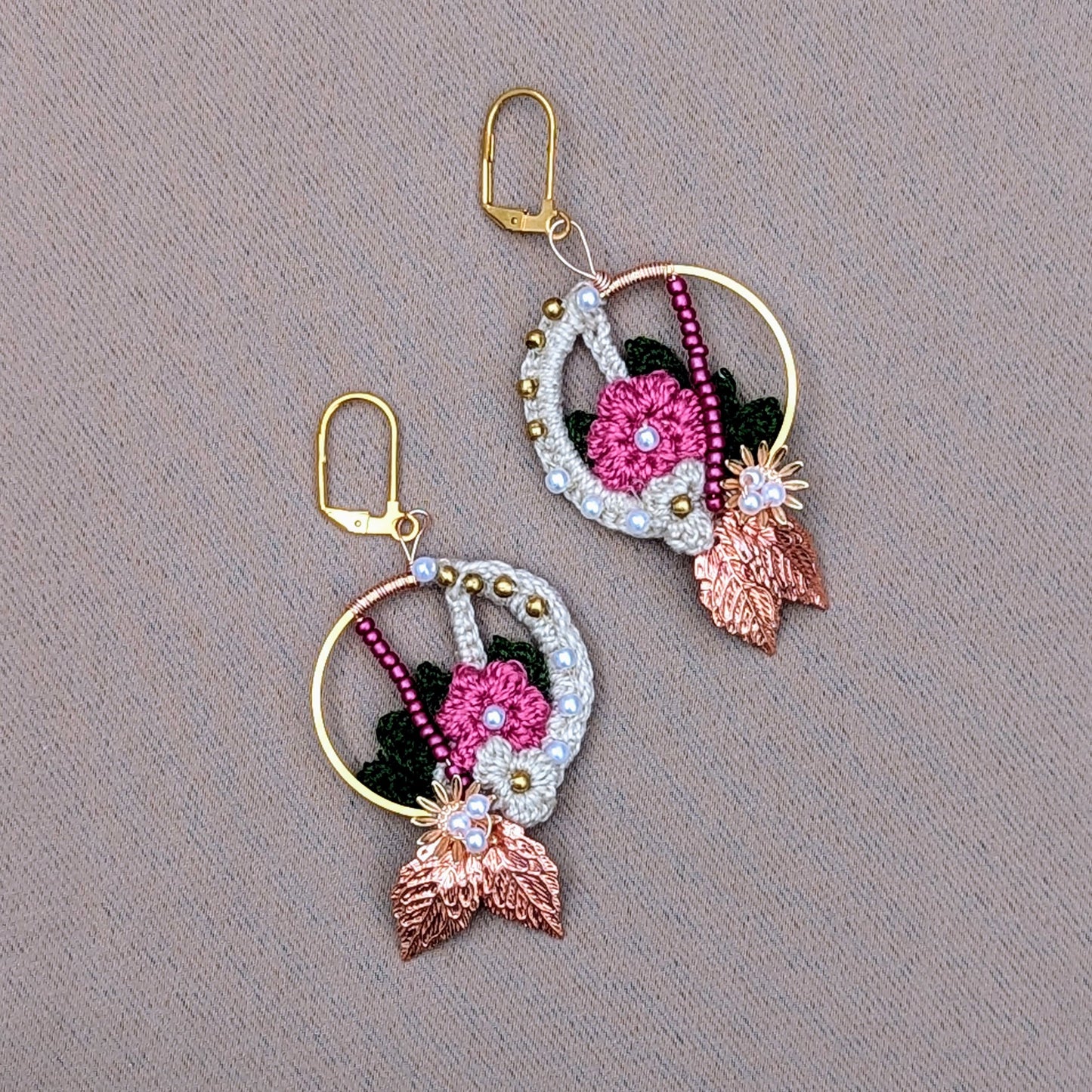 A beautiful pair of handcrafted Indian inspired floral motif earrings exclusive to sustainable brand Mayaani Jewellery UK featuring an stunning blend of cream, pink and dark green floral and leaf inspired elements adorned with solid brass, pink and seed pearl beads. Finished with brilliant rose gold leaves and gold plated stainless steel earring clasps. This lightweight, show stopping accessory is perfect for everything from weddings  and special occasions to everyday. 
