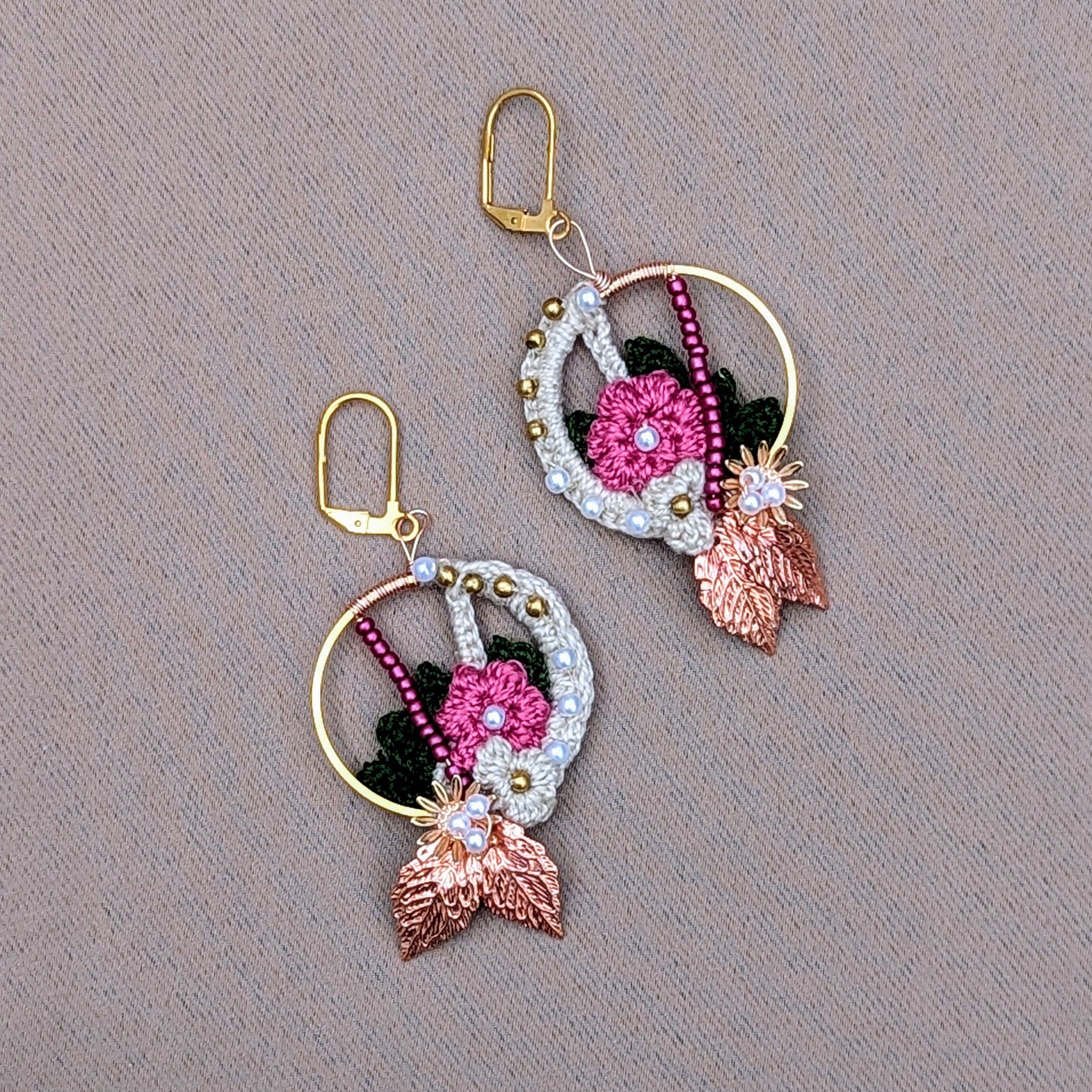 A beautiful pair of handcrafted Indian inspired floral motif earrings exclusive to sustainable brand Mayaani Jewellery UK featuring an stunning blend of cream, pink and dark green floral and leaf inspired elements adorned with solid brass, pink and seed pearl beads. Finished with brilliant rose gold leaves and gold plated stainless steel earring clasps. This lightweight, show stopping accessory is perfect for everything from weddings  and special occasions to everyday. 