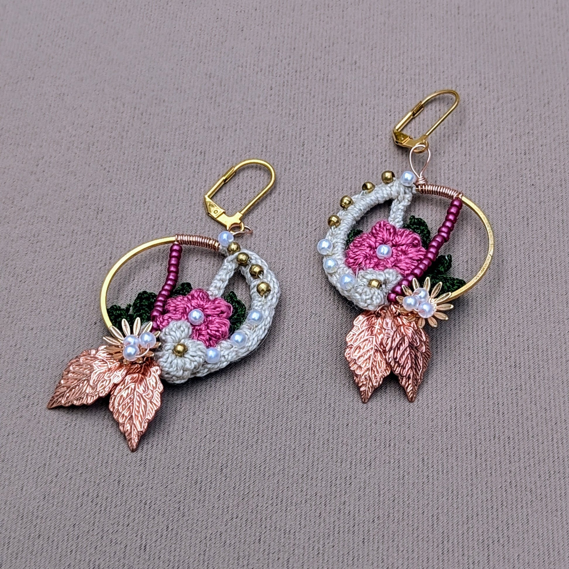 Elevate your style with handcrafted Indian-inspired earrings from Mayaani Jewellery, a sustainable UK brand. Featuring cream, pink, and dark green floral and leaf designs, along with solid brass, pink, and seed pearl beads, they are completed with rose gold leaves and gold-plated stainless steel clasps. Lightweight and striking, these earrings are perfect for weddings, special occasions, and everyday elegance.
