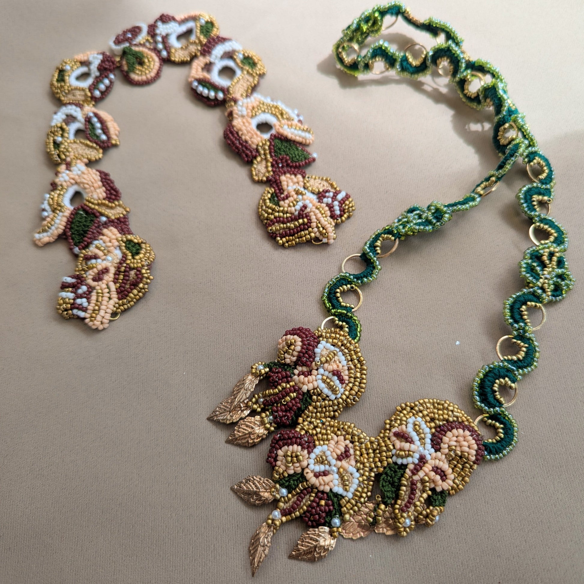 A pair of artisan handmade couture jewellery pieces by Mayaani Jewellery UK featuring two interchangeable chains to accompany a floral motif central pendant complete with rose gold plated leaves.