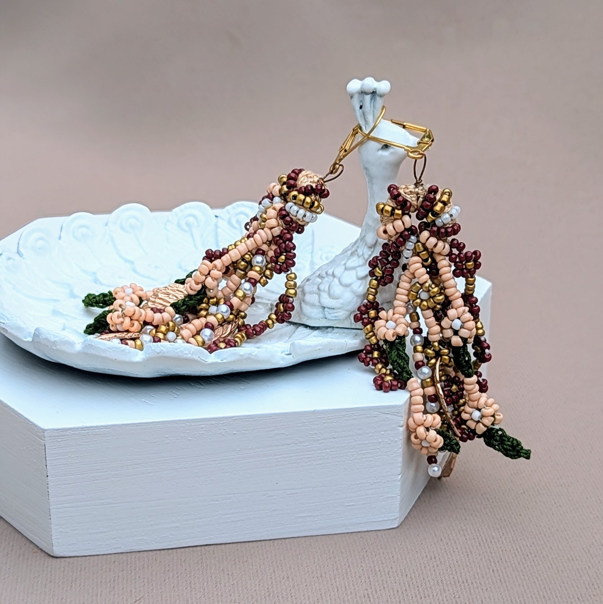 Statement Indian wedding occasion earrings with cascading beaded strands in traditional bridal colours. Designed by Mayaani Jewellery UK using sustainable techniques and gold-plated stainless steel hypoallergenic hooks. 