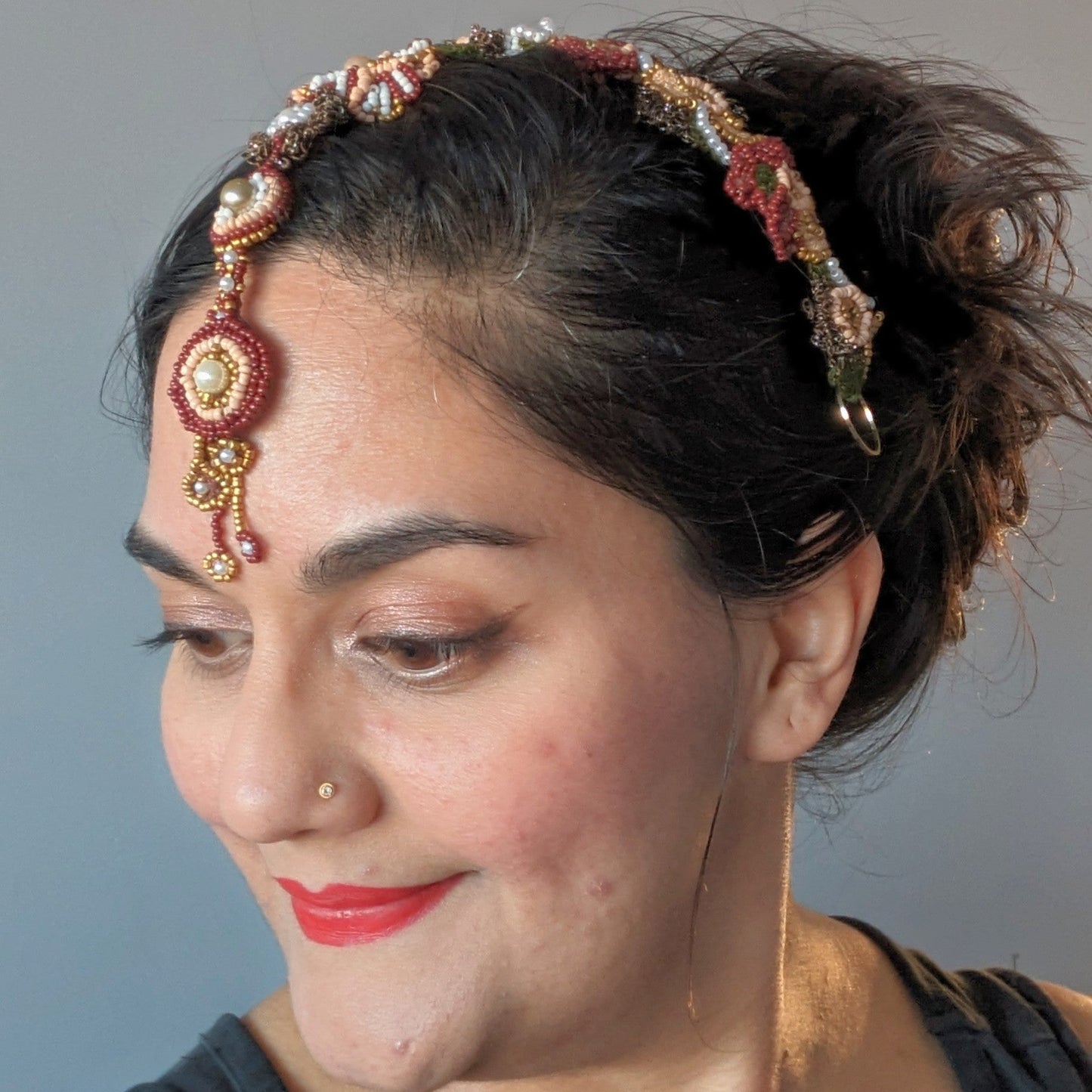 Mayaani Jewellery Aishwarya statement couture beaded detachable headpiece in red, green, gold and pearl accents modelled on  Mayaani founder Megha.