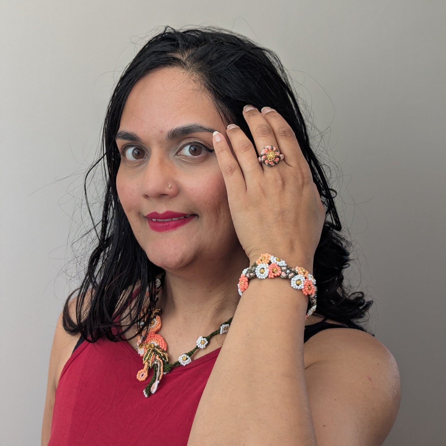 Mayaani Jewellery UK designer Megha modelling the Padmika 5-in-1 Indian haath phool worn as a ring, necklace and separate Western style bracelet element.