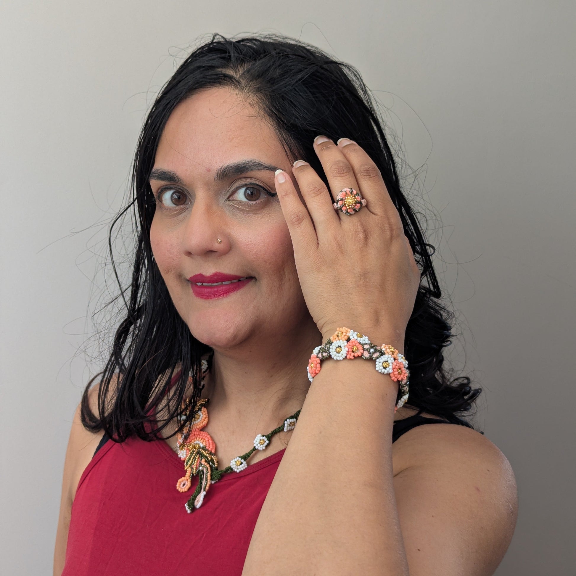 Mayaani Jewellery UK designer Megha modelling the Padmika 5-in-1 Indian haath phool worn as a ring, necklace and separate Western style bracelet element.