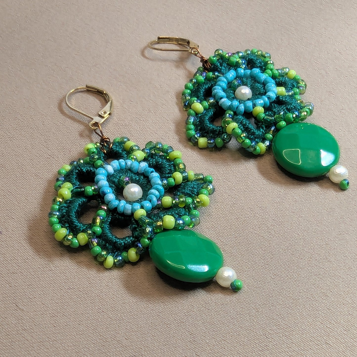Avika green floral statement earrings handmade in the UK with layered crochet beadwork, vintage seed pearls and bold green bead drops.