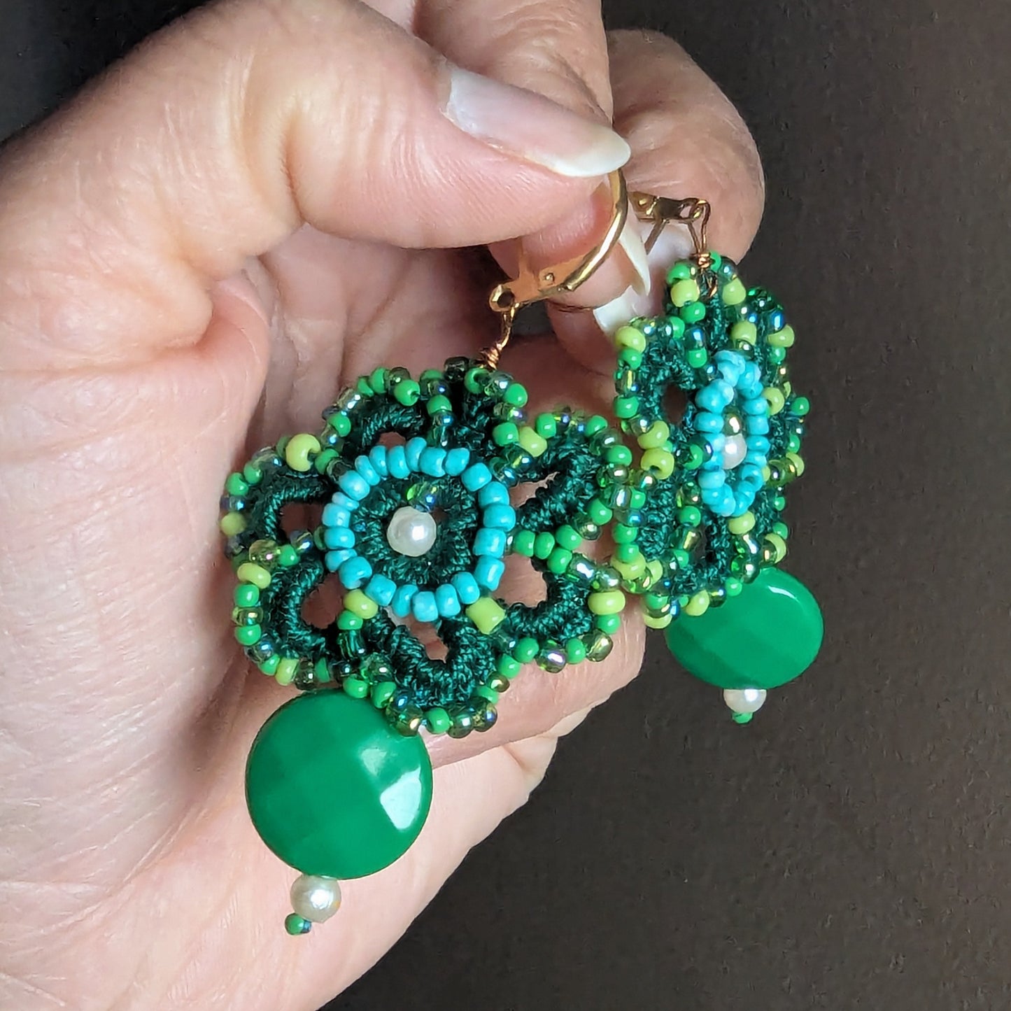 Close view of Avika green beaded flower earrings with vintage pearls and antique bronze wire, one-of-a-kind sustainable jewellery made in the UK.