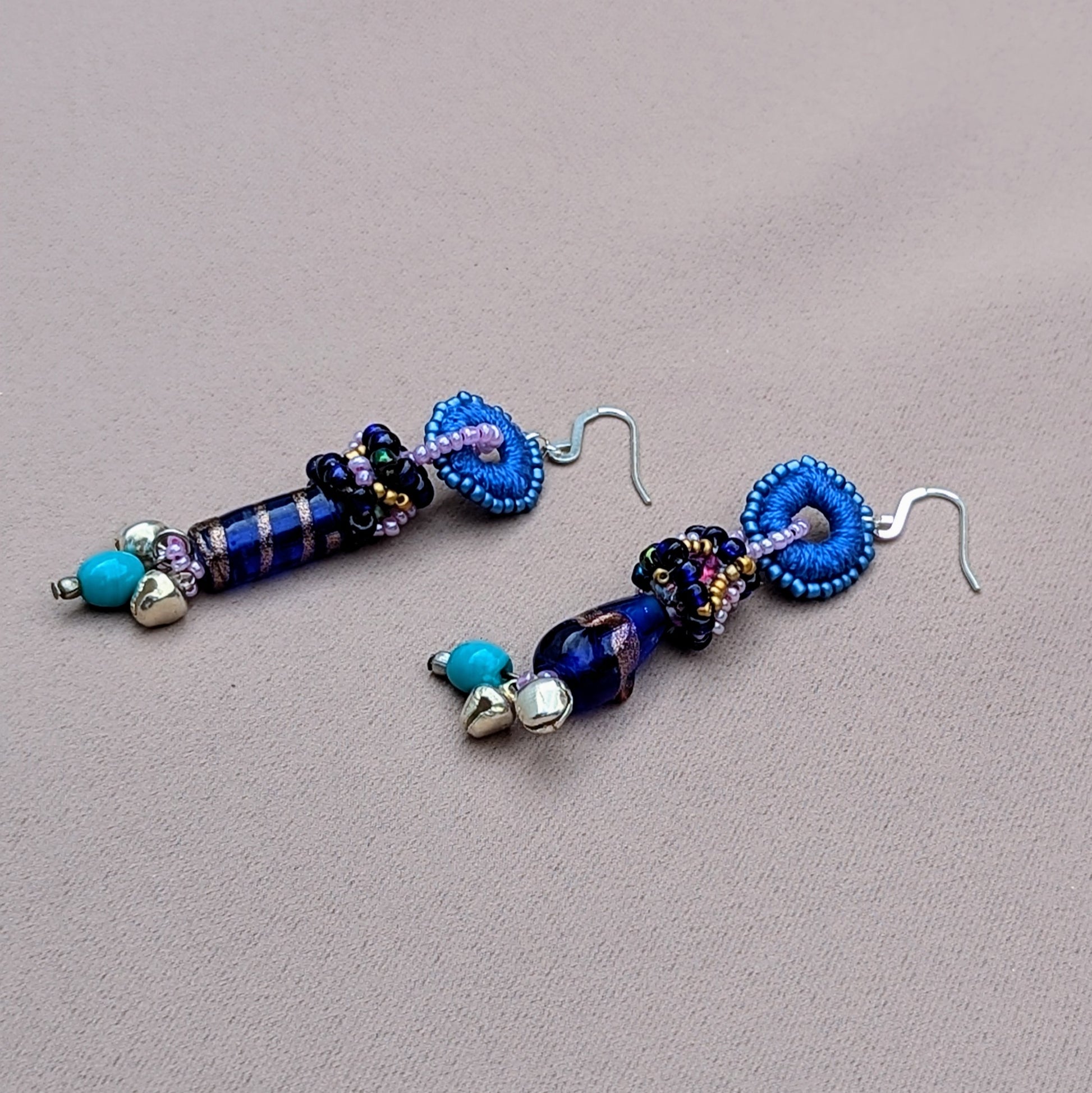 Pair of Mayaani sustainable earrings featuring solid silver ghungroo bells and fine crochet craftsmanship.