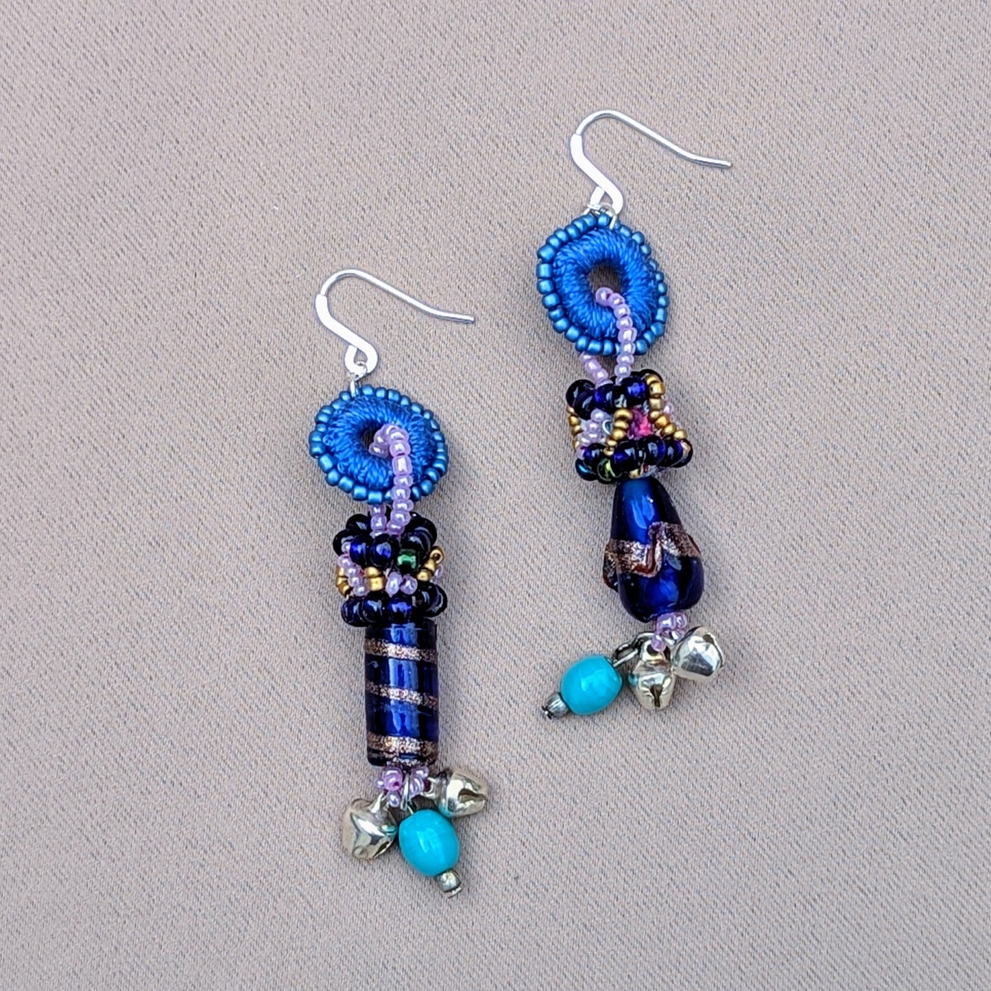 Asymmetric blue and silver scrap bead statement earrings with ghungroo bells handcrafted by Megha of Mayaani Jewellery UK.