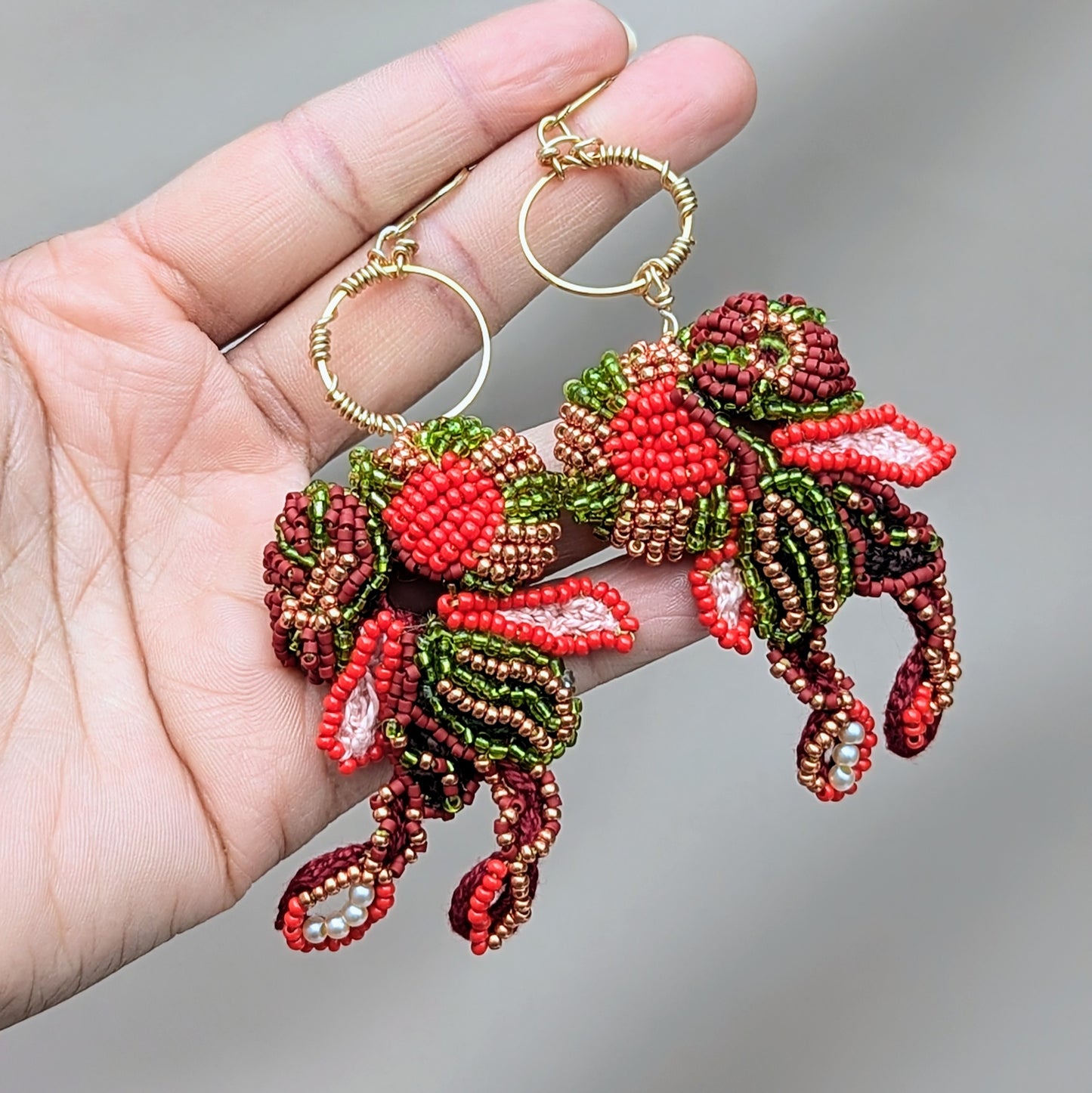Tamira red green gold statement beaded Indian earrings handcrafted with glass seed beads and gold hoops.
