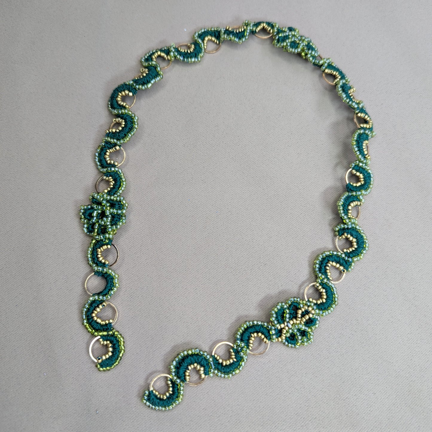Rukmini artisan hand woven bead crochet chain in emerald and olive green with gold hoops exclusively made to order at Mayaani Jewellery UK.