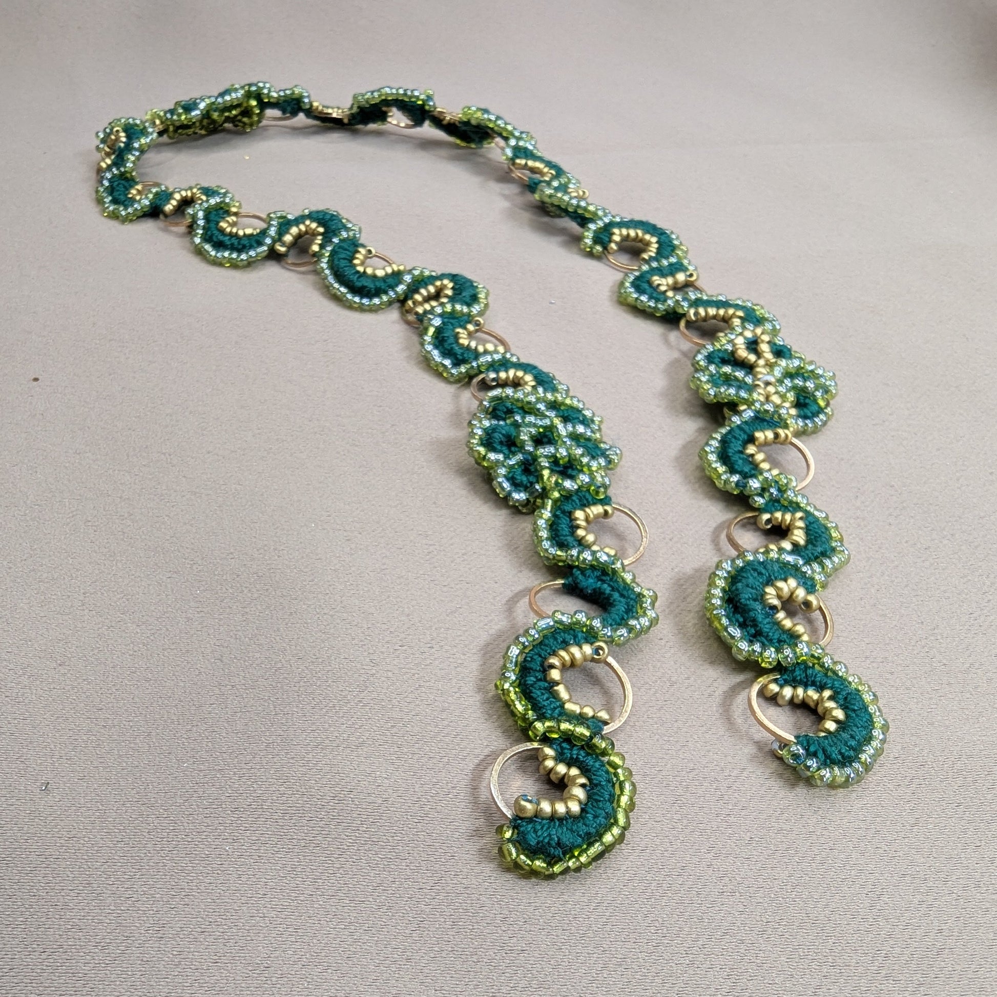 Handmade Rukmini emerald green pearl cotton, silver lined seed bead and gold stainless steel statement chain by Mayaani Jewellery UK.