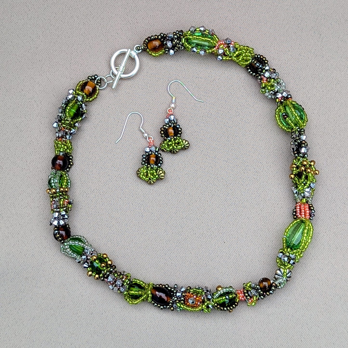 Handmade brown and green statement necklace with matching earrings by Mayaani Jewellery, inspired by nature and crafted from glass seed beads.