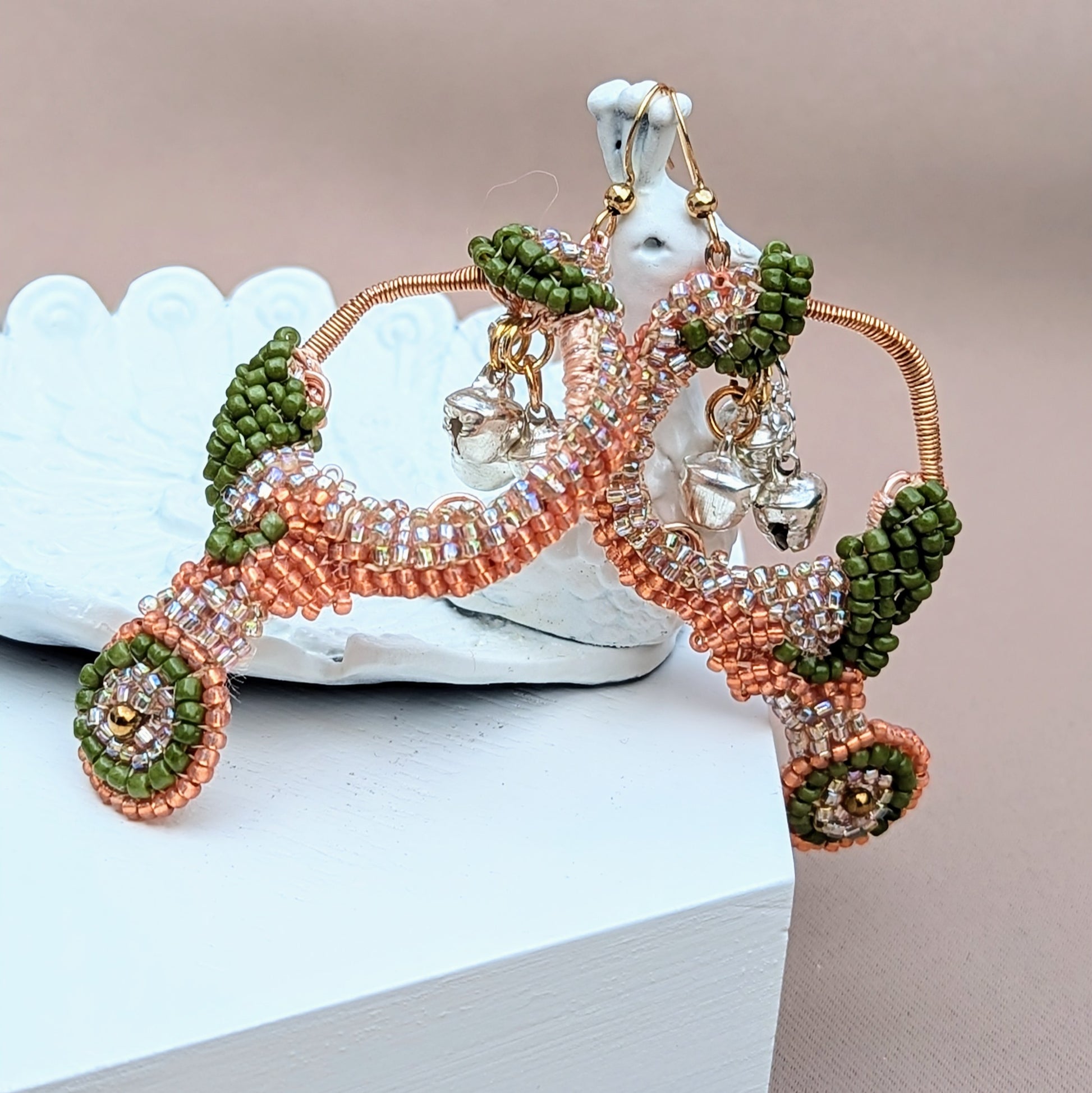 Indian-inspired statement earrings in peach, silver, and green with intricate bead crochet and silver ghungroo bells, handcrafted in the UK by Mayaani Jewellery.