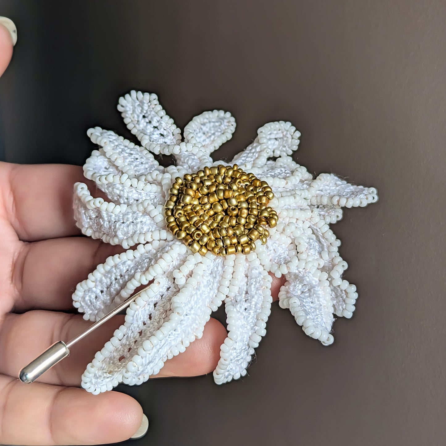 Daisy handmade floral brooch side view showcasing sculptural white petals and a rich gold seed bead centre exclusively handmade for Mayaani Jewellery UK.
