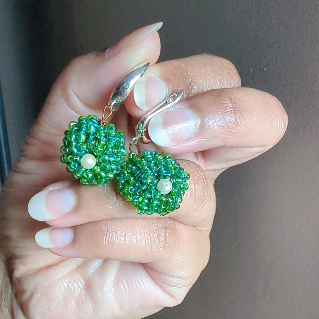 Close-up of Vasanti earrings highlighting detailed bead weaving and antique bronze wirework.