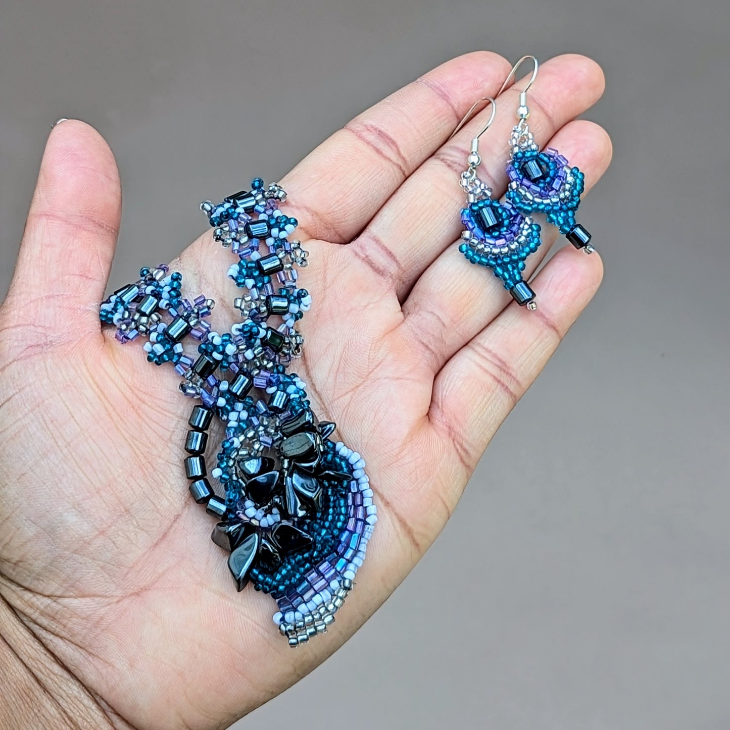 Handcrafted lilac and hematite necklace and complementary earrings made from upcycled vintage beads, designed by Mayaani Jewellery UK.