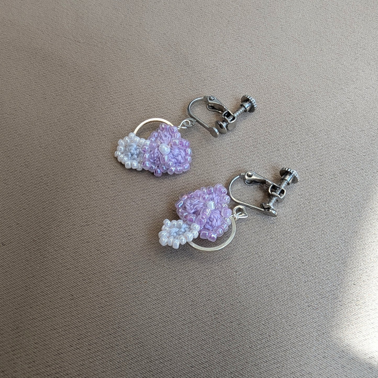 Malti earrings showing stainless steel screw-back clip-on clasps - handmade lilac crochet flower earrings by Mayaani Jewellery.