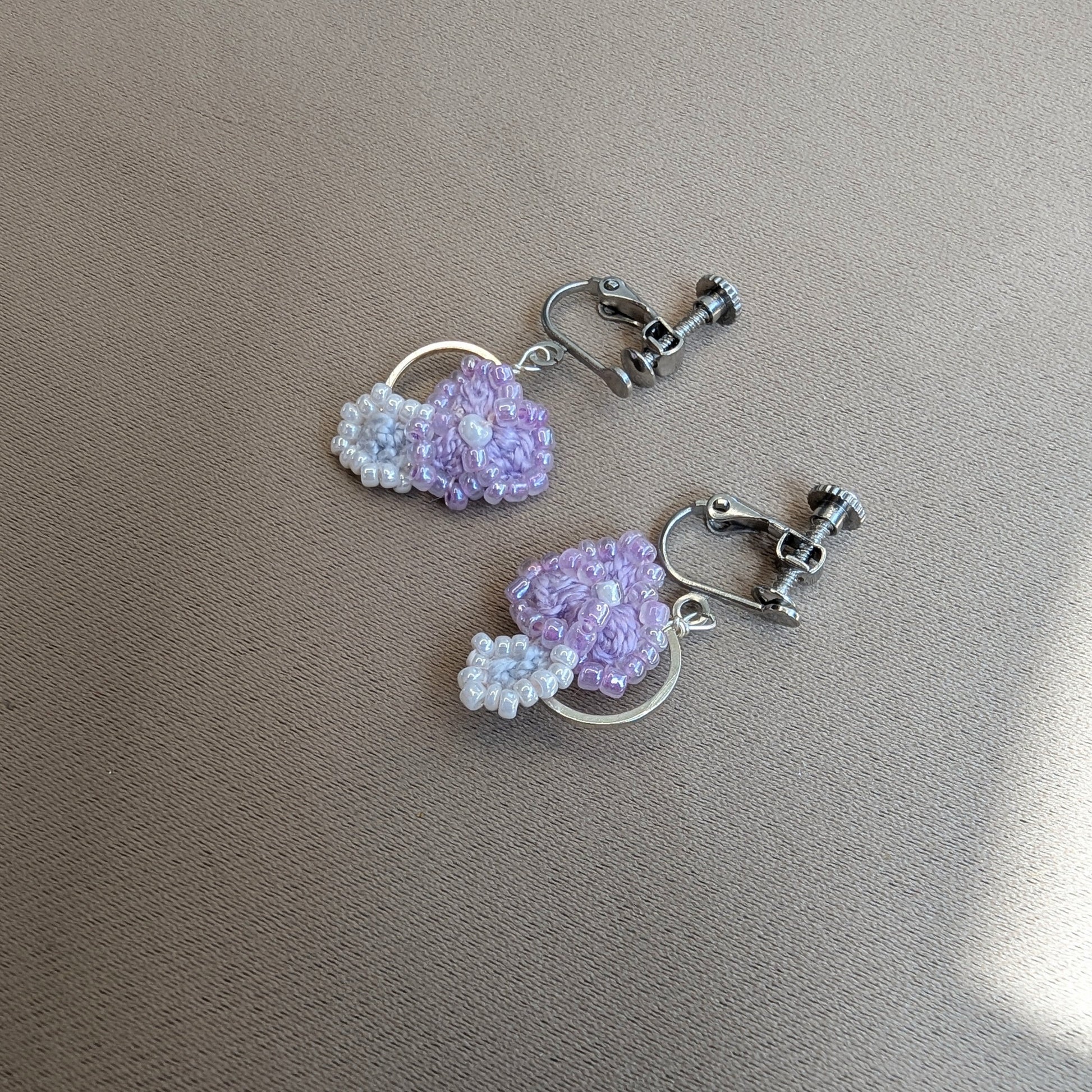 Malti earrings showing stainless steel screw-back clip-on clasps - handmade lilac crochet flower earrings by Mayaani Jewellery.