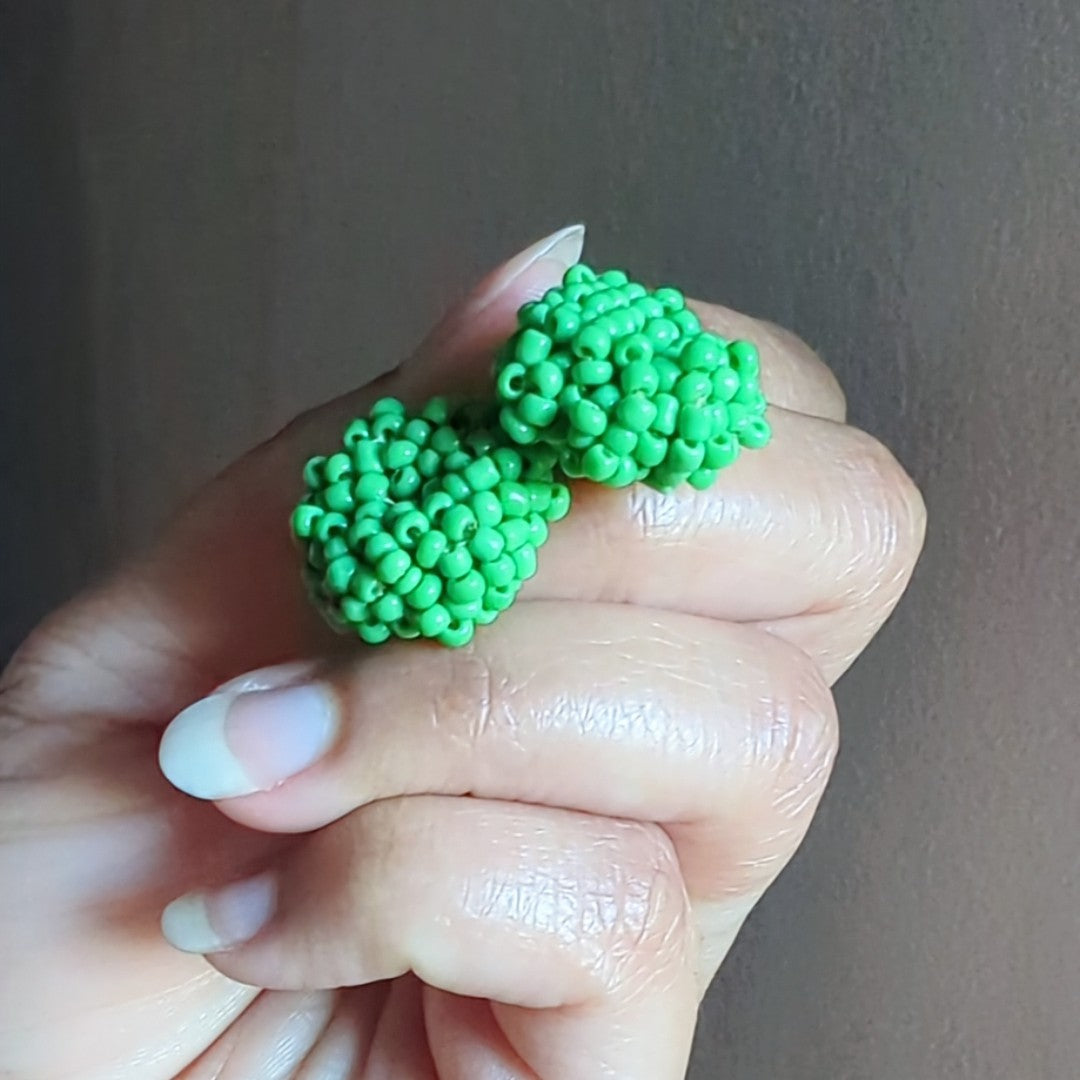 Masi Harita earrings photographed in natural light capturing luminous green tones and artisanal finish.