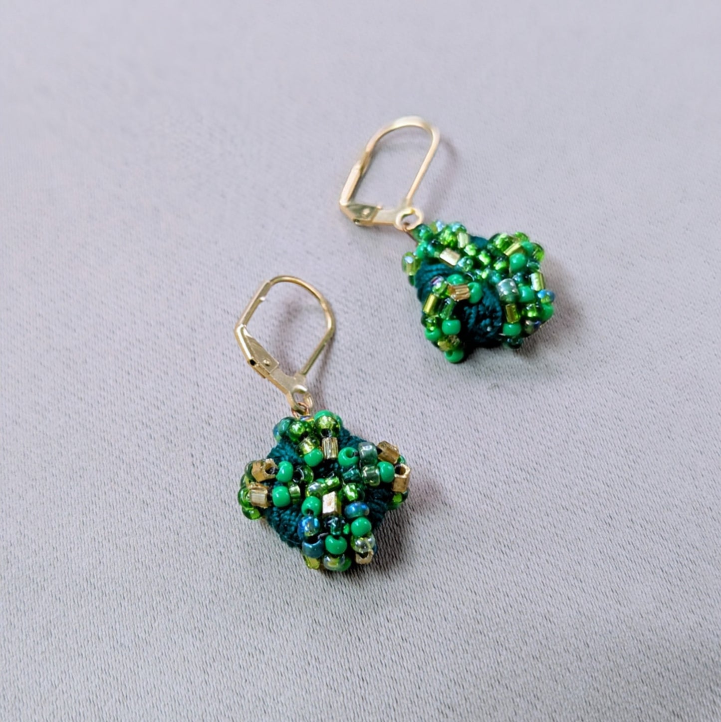 Handwoven one-of-a-kind green and gold vintage glass seed bead earrings designed and slow made.