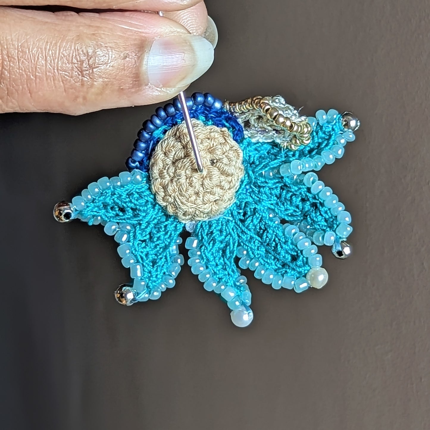 Back view of sculptural turquoise Jalika brooch made with reclaimed vintage beads and pearl cotton threads. Sustainable handmade jewellery UK.