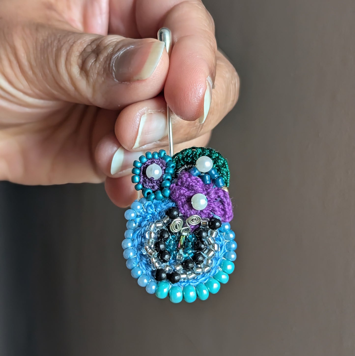 Kairavi artisan brooch pin featuring turquoise seed beads, vintage butterfly beadwork and stainless steel pin.