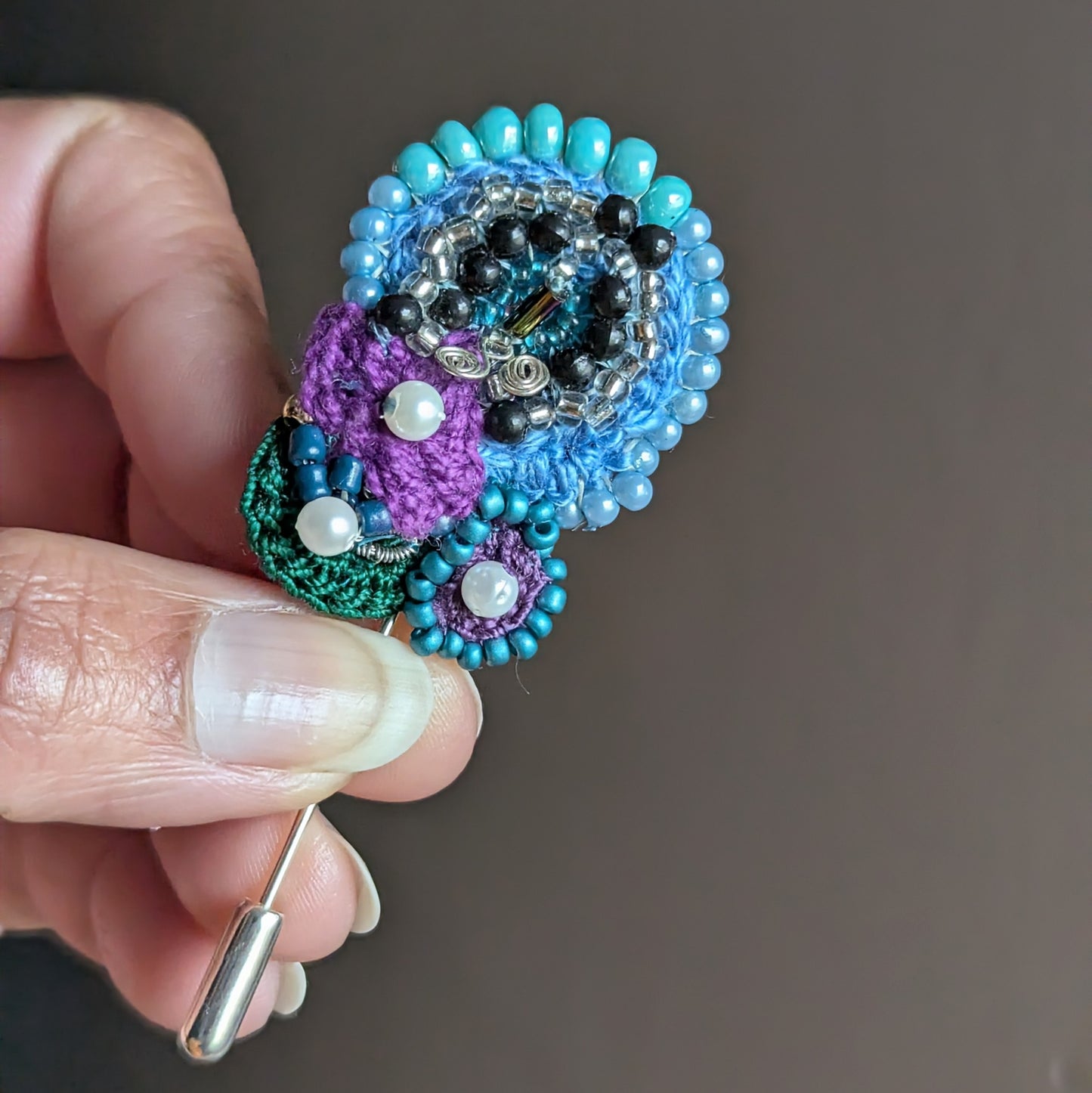 Front view of Kairavi one of a kind butterfly brooch handmade with crochet beadwork and mixed vintage seed beads.