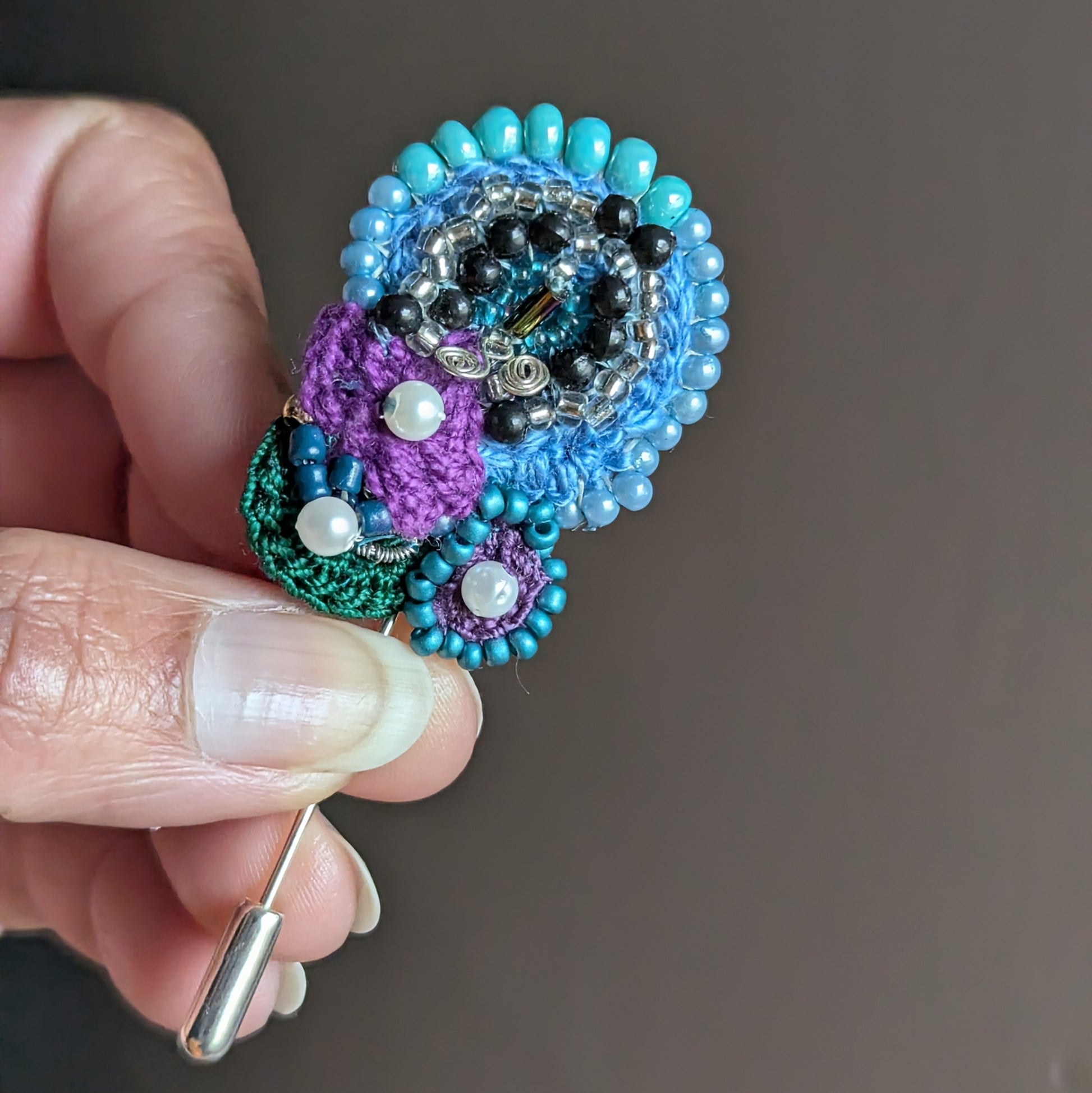 Front view of Kairavi one of a kind butterfly brooch handmade with crochet beadwork and mixed vintage seed beads.