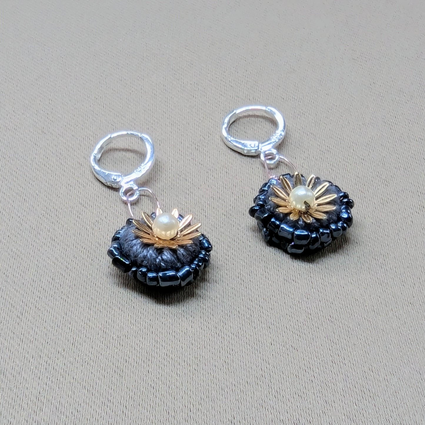 One-of-a-kind Karishma earrings with crochet centre, gold-plated flowers, and sterling silver clasps. Artisan handmade in the UK.