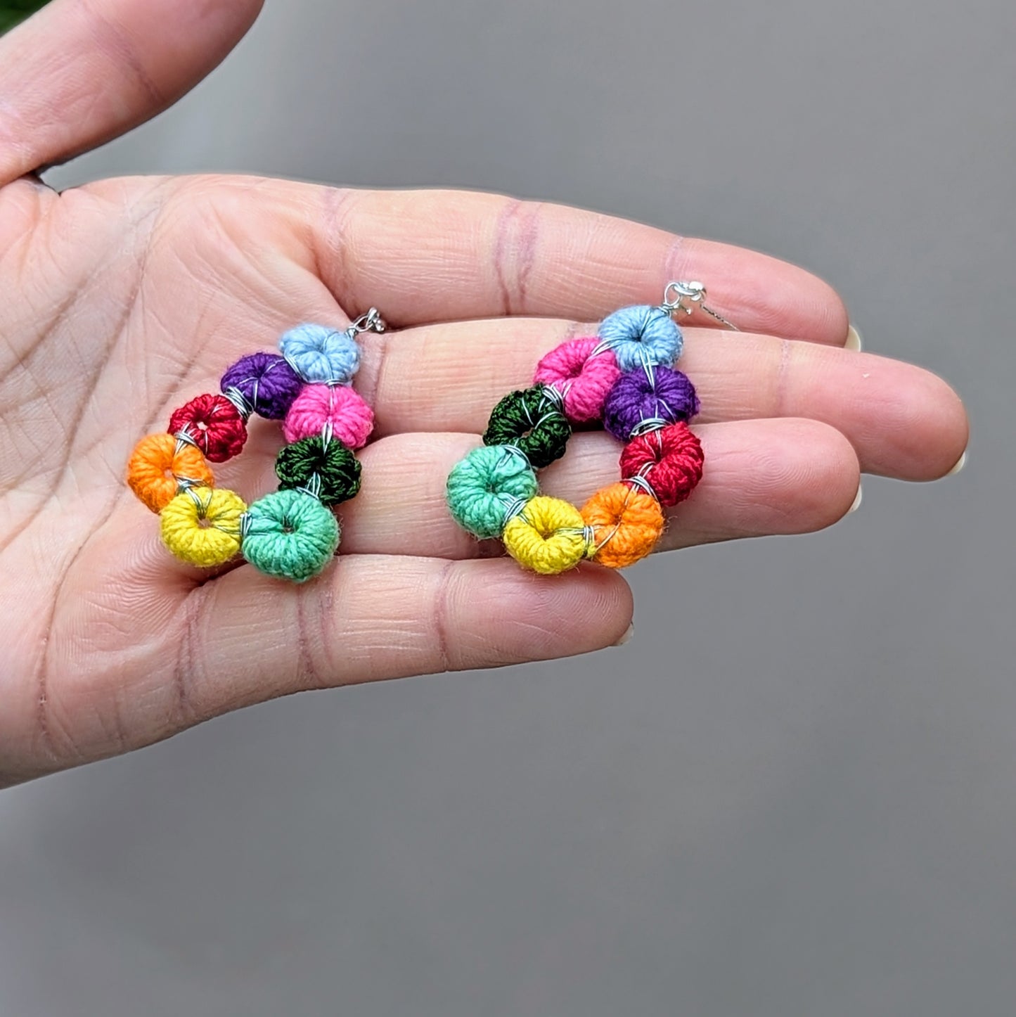 Komali Hope Springs rainbow teardrop crochet earrings, handmade in the UK with sterling silver lever back hooks.