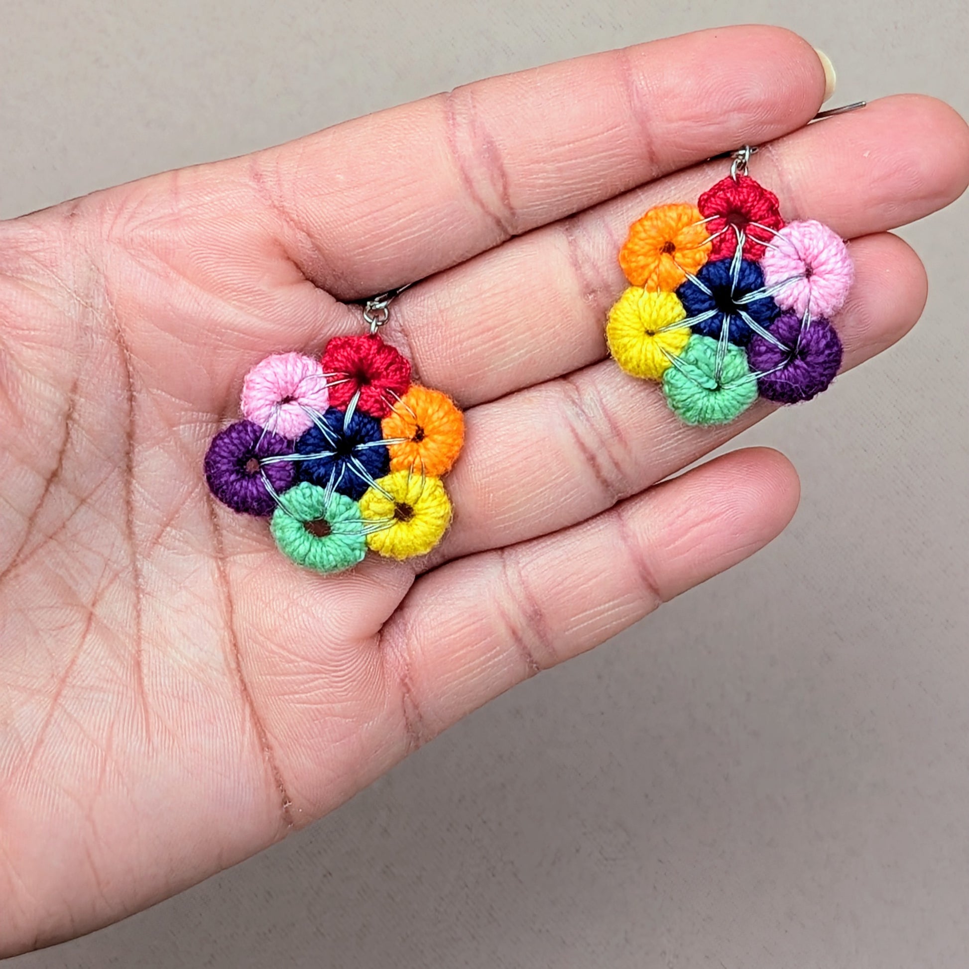 Handmade rainbow circle drop earrings in crochet threadwork with silver-toned wire details, Komali Chakra by Mayaani Jewellery.