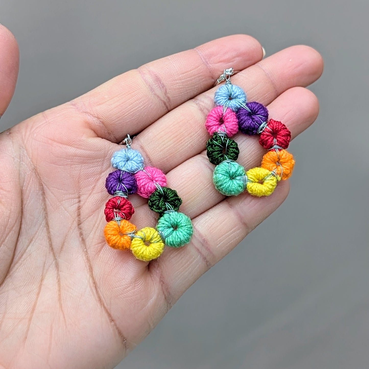 Handmade rainbow teardrop earrings formed from crocheted cotton circles, Komali Hope Springs by Mayaani Jewellery.